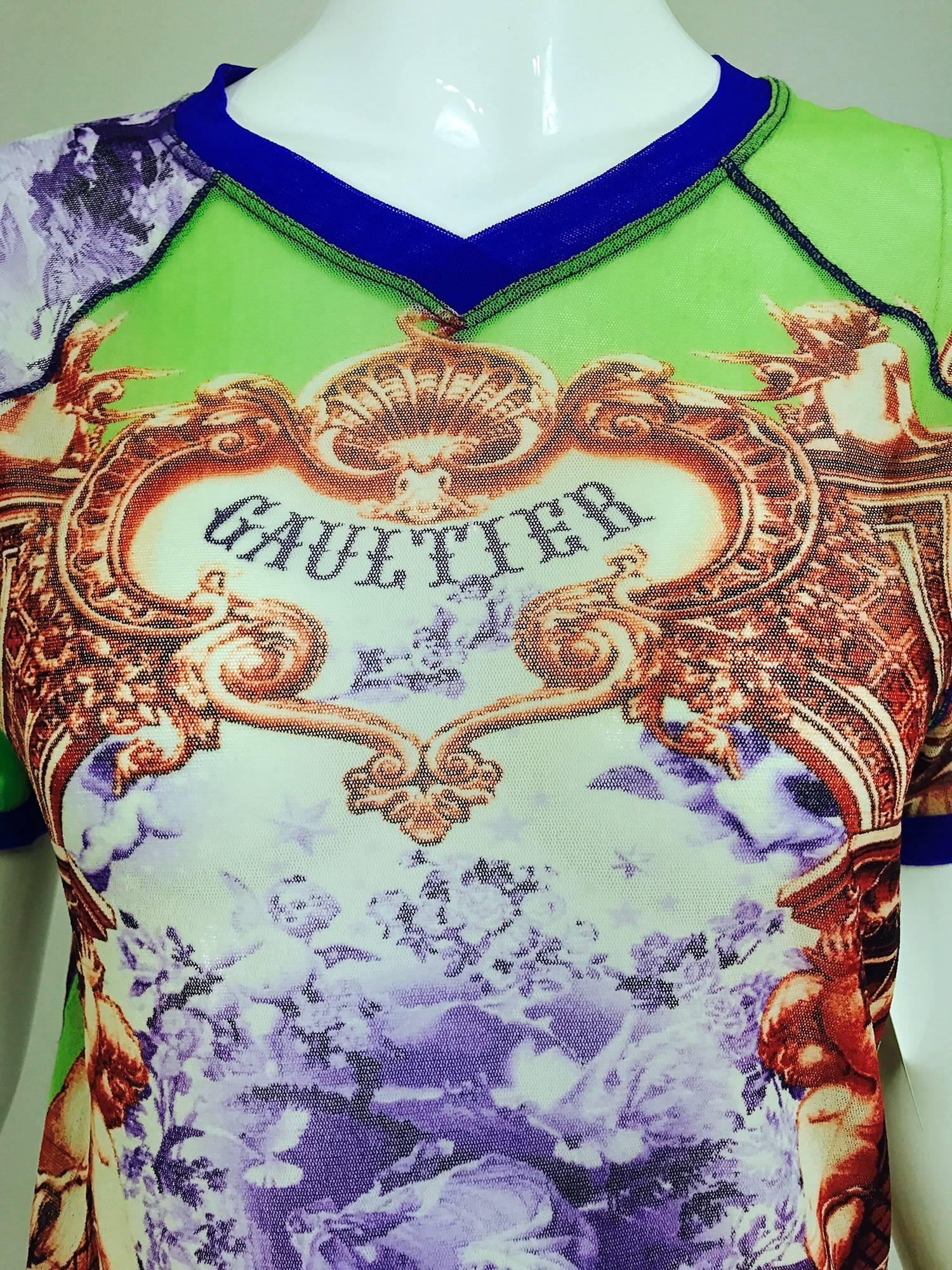 Jean Paul Gaultier colourful mesh top, V neckline, short raglan sleeves, fitted and stretchy. Fits a size S-M. Great graphics!

In excellent wearable condition... All our clothing is dry cleaned and inspected for condition and is ready to wear...Any