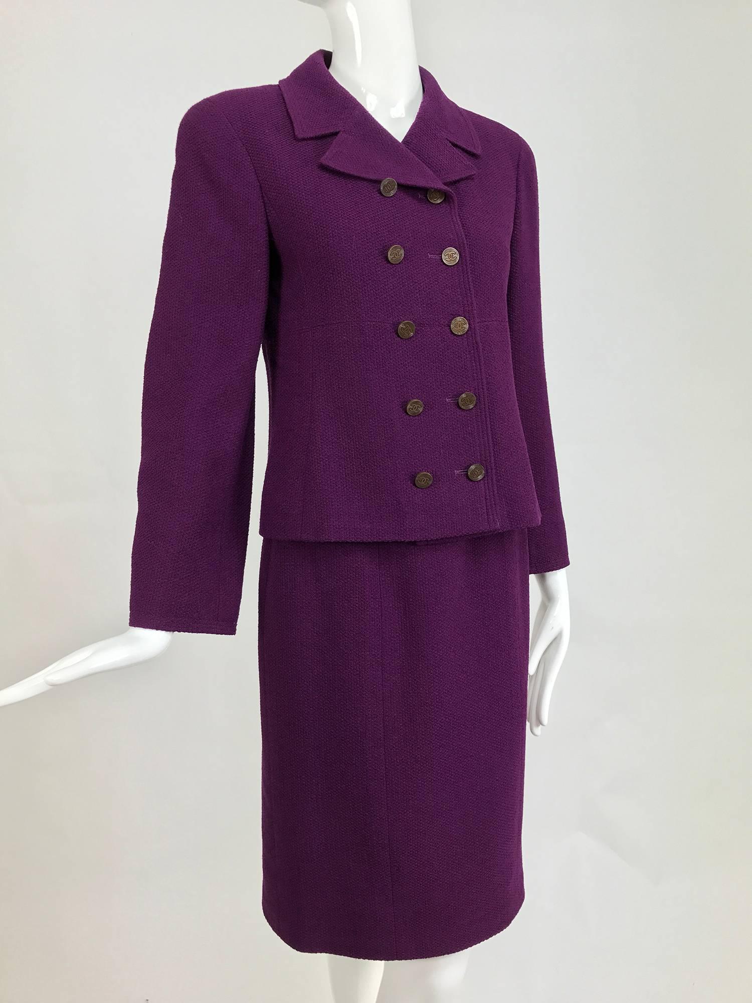 Chanel aubergine boucle classic double breasted skirt suit 1998A...Double breasted jacket with princess seams, high notched lapel, hip bone length, jacket is slightly fitted through the waist ...Long sleeves, closes with copper colour logo