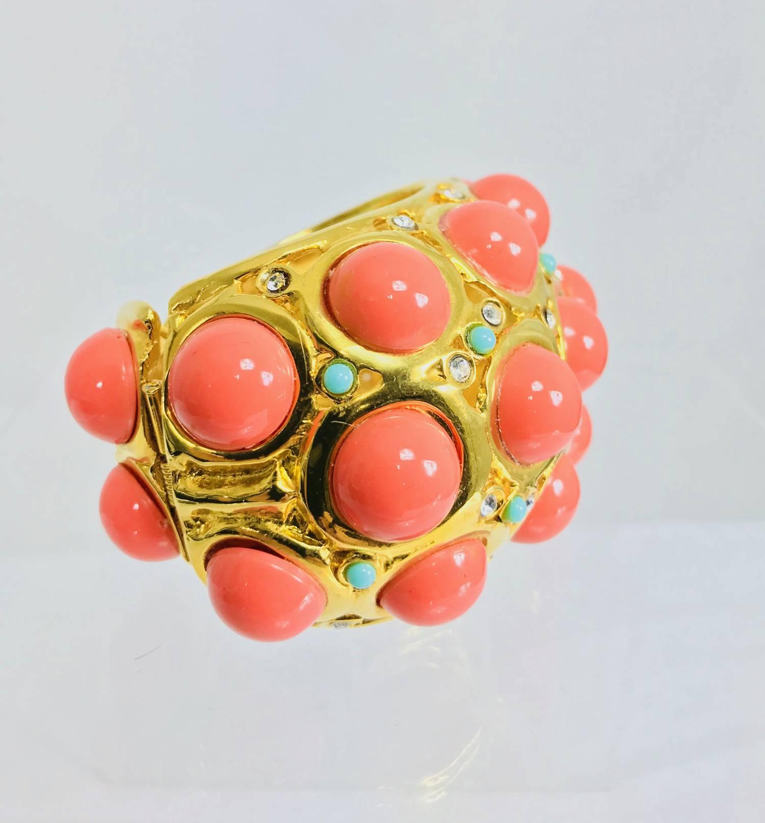 Fabulous Kenneth Lane large chunky open work gold cuff bracelet set with large faux coral cabochons, small turquoise cabochons and crystal rhinestones. A cuff style with one side hinged at the back to make it easier to put on. Marked Kenneth Lane