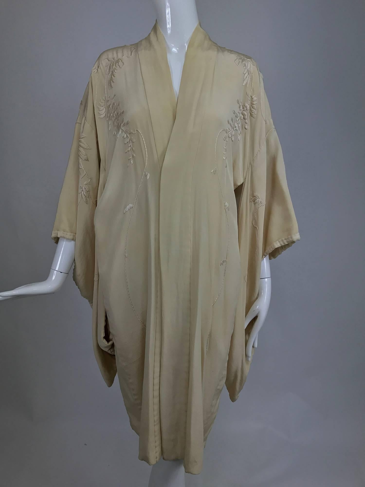 Romantic wisteria embroidered cream silk short kimono from the 1920s, this beautiful piece is lined in lightweight cream silk brocade with a floral pattern...Lush satin stitch embroidery of cascading wisteria...Deep kimono sleeves, this piece is
