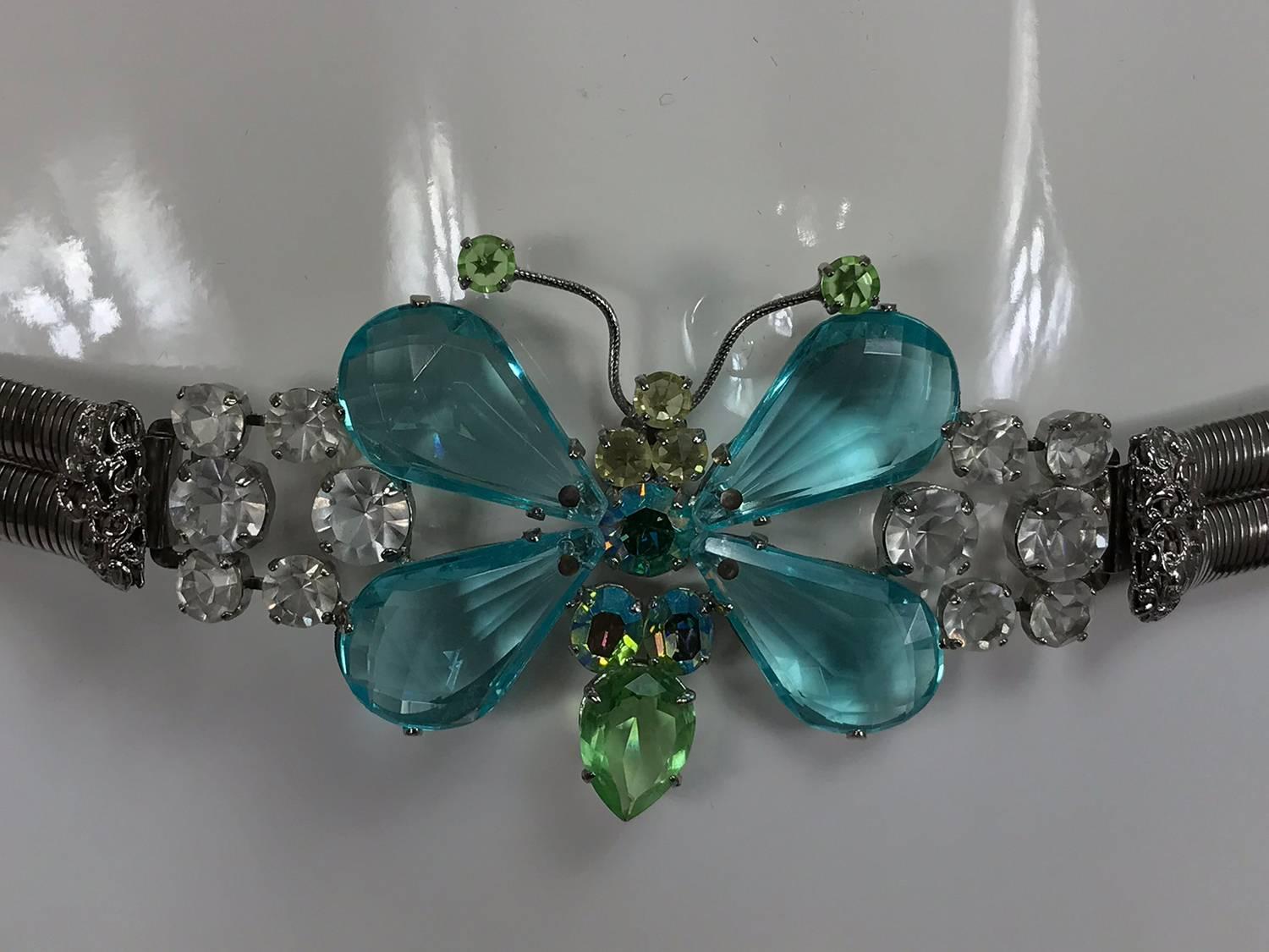 Schreiner New York signed aqua green crystal with silver metal stretch belt from the 1960s...Large and beautiful butterfly buckle with coloured Lucite wings with prong set crystal rhinestones...Stretch metal belt in excellent condition.
Measurements