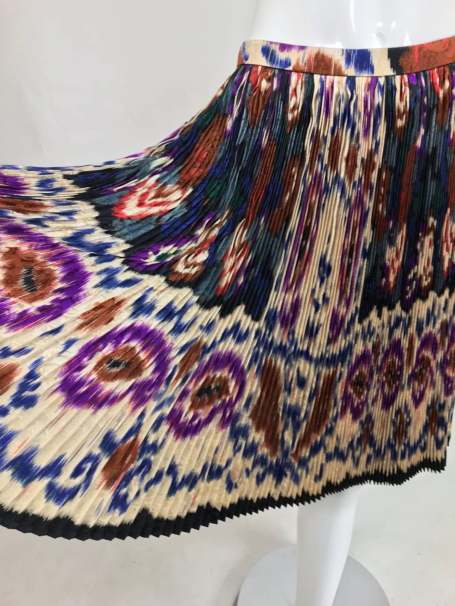 Vintage Ungaro rich colour silk jacquard ikat print knife pleated skirt and coordinating top from the 1980s...The top has a high pleated neck, closes at the side front with black faceted glass buttons to the waist...The sleeves are gathered at the