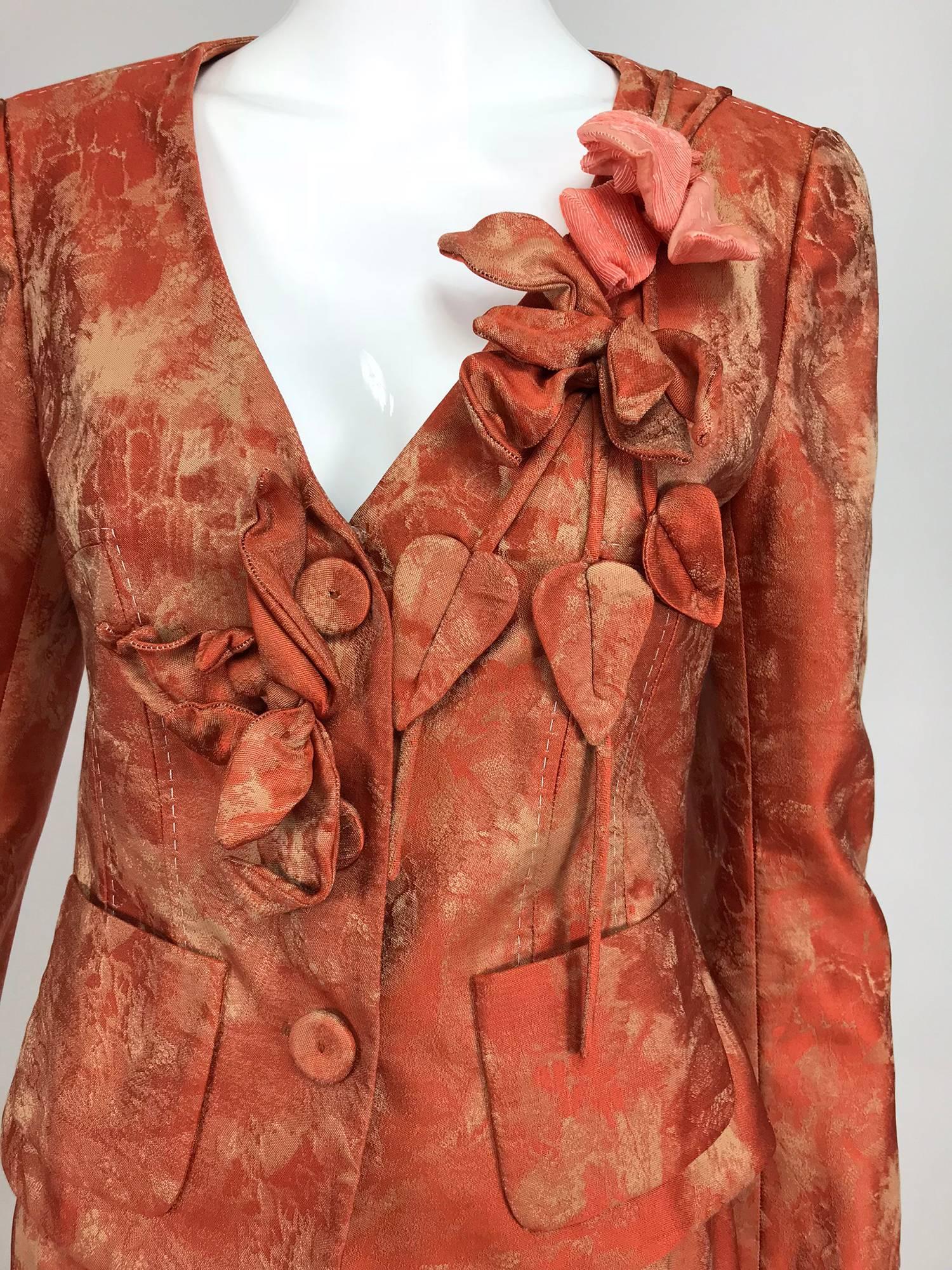 Christian LaCroix red and beige brocade floral applique skirt set...The v front collarless jacket has a large dimensional flower applique corsage at either front...Princess seamed, with decorative top stitching on many seams...Front hip patch