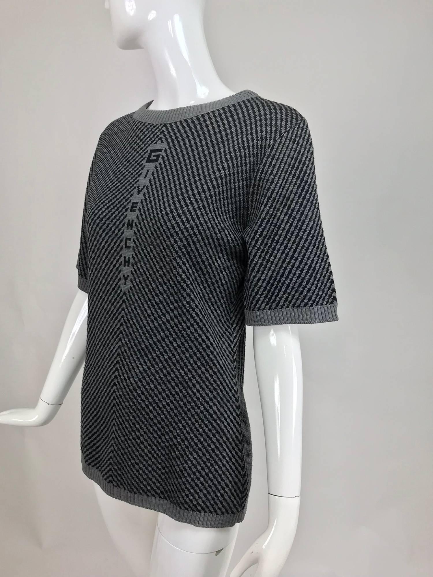 Vintage Givenchy sport 1980s novelty knitted sweater. Dark and light grey geometric knit sweater with Givenchy at the front. Ribbed neckline, cuffs and hem. Pull on sweater, fits like a size Medium.

In excellent wearable condition... All our