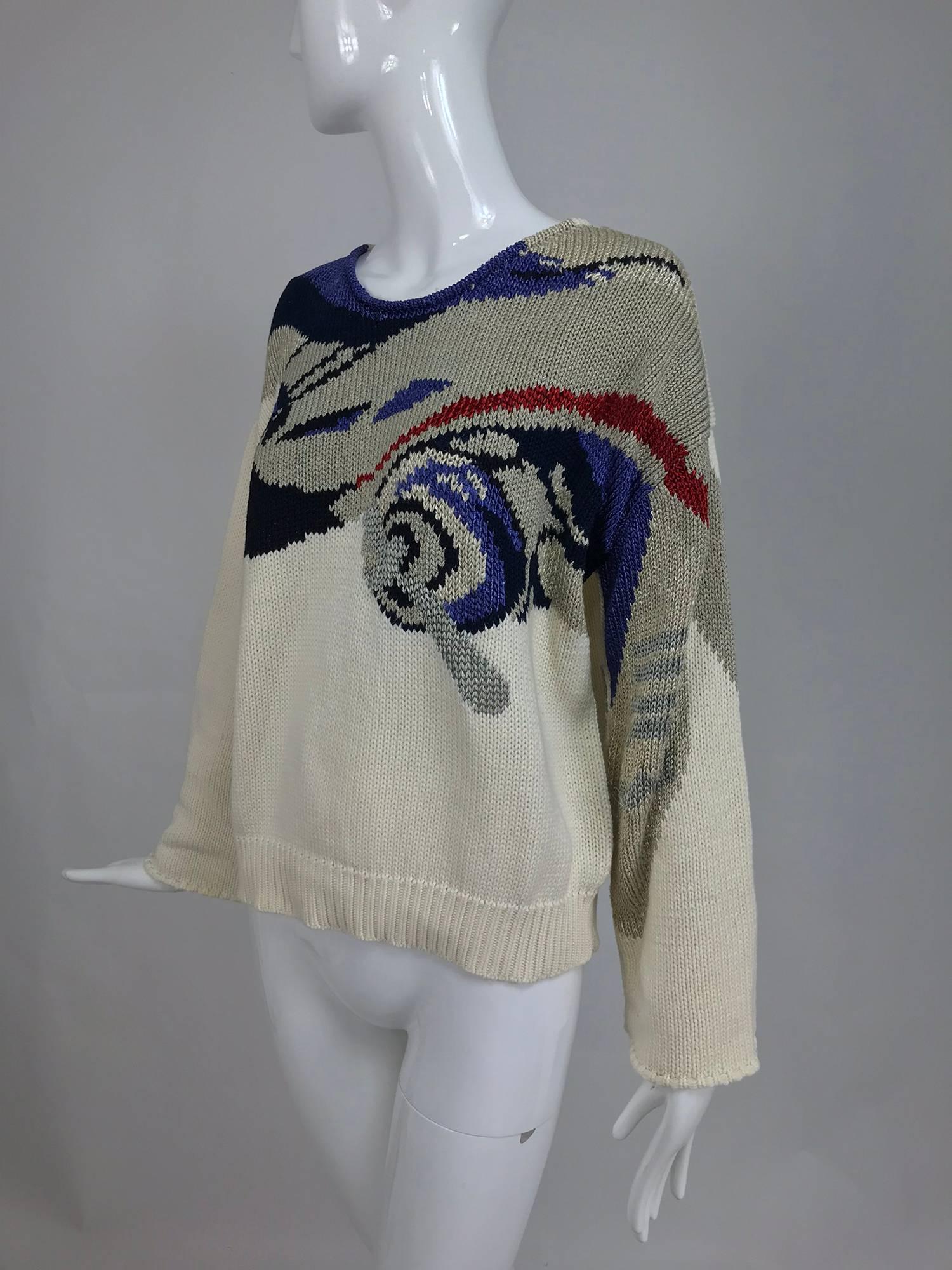 Krizia vintage airplane cotton and rayon knit pullover sweater...Round neck sweater features a large airplane on the shoulder and at the front, cream ground with the plane in blues, black silver and red...Long sleeves straight sleeves with overcast