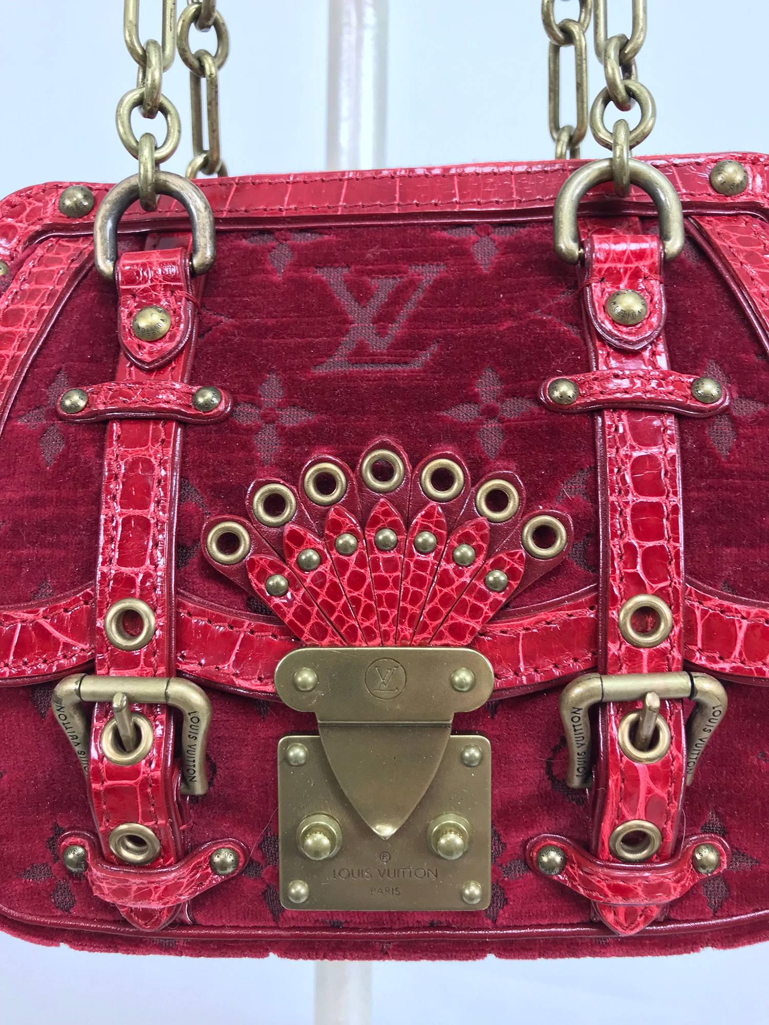 Louis Vuitton Velours Alligator Gracie PM was a limited edition piece from the Fall/Winter 2004 Runway Collection. Monogrammed rich red velvet is luxuriously trimmed in red alligator. Hardware has a patina finish that compliments the design of the