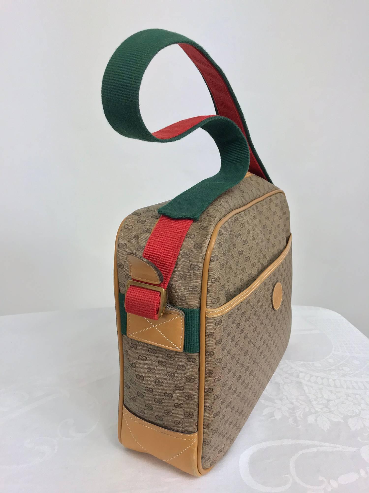 Vintage Gucci logo coated canvas leather trim shoulder tote 1980s...Good size tote with red and green webbing shoulder strap, leather cording and trims, gold hardware...Front side compartment closes with hidden red Velcro...Inside there is a