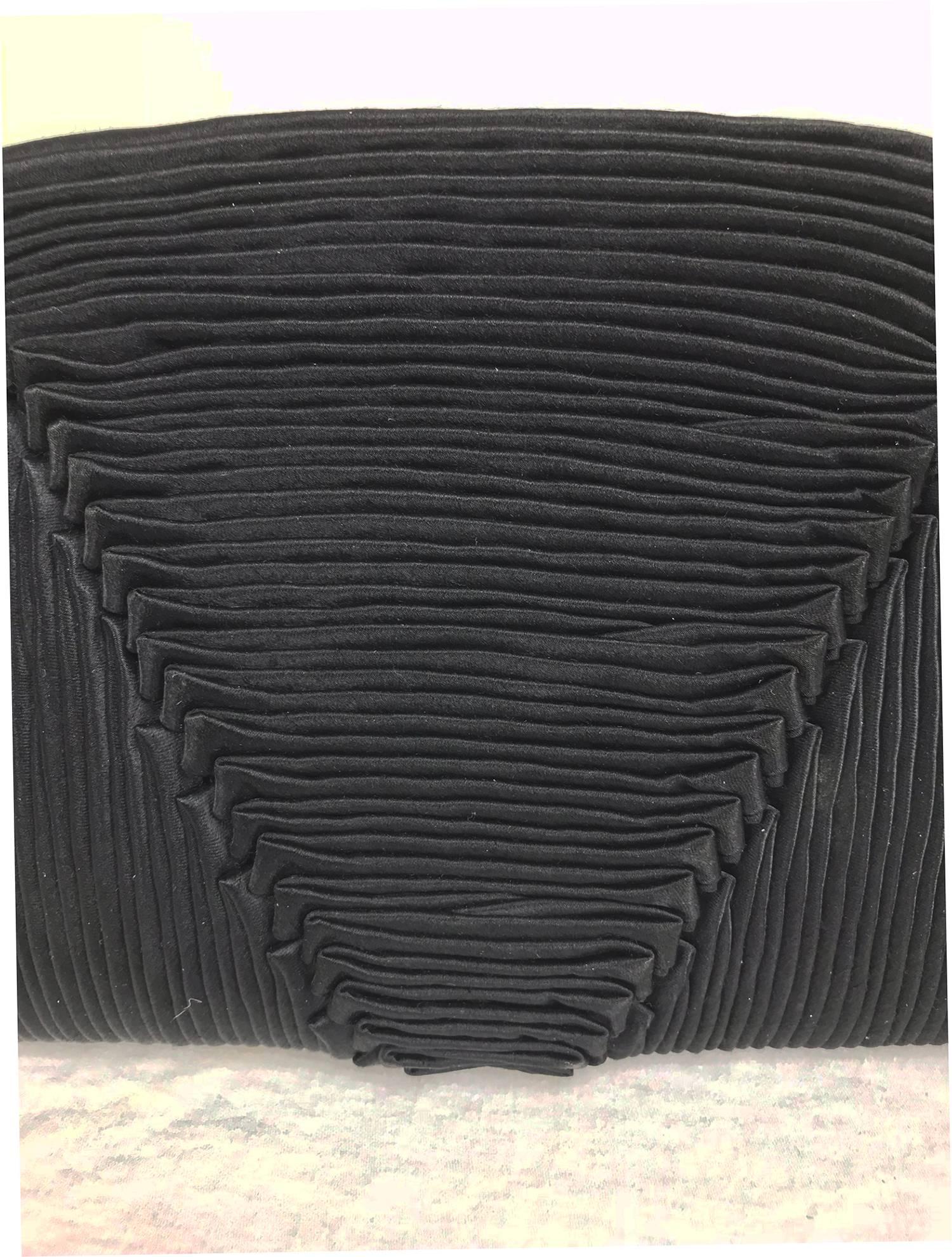 Bergdorf Goodman hand pleated black silk evening clutch 1930s. This beautiful bag is a work of art, hand pleated in a geometric pattern, the bag is very tactile and will look beautiful with any outfit. Fully lined in black silk satin, with the