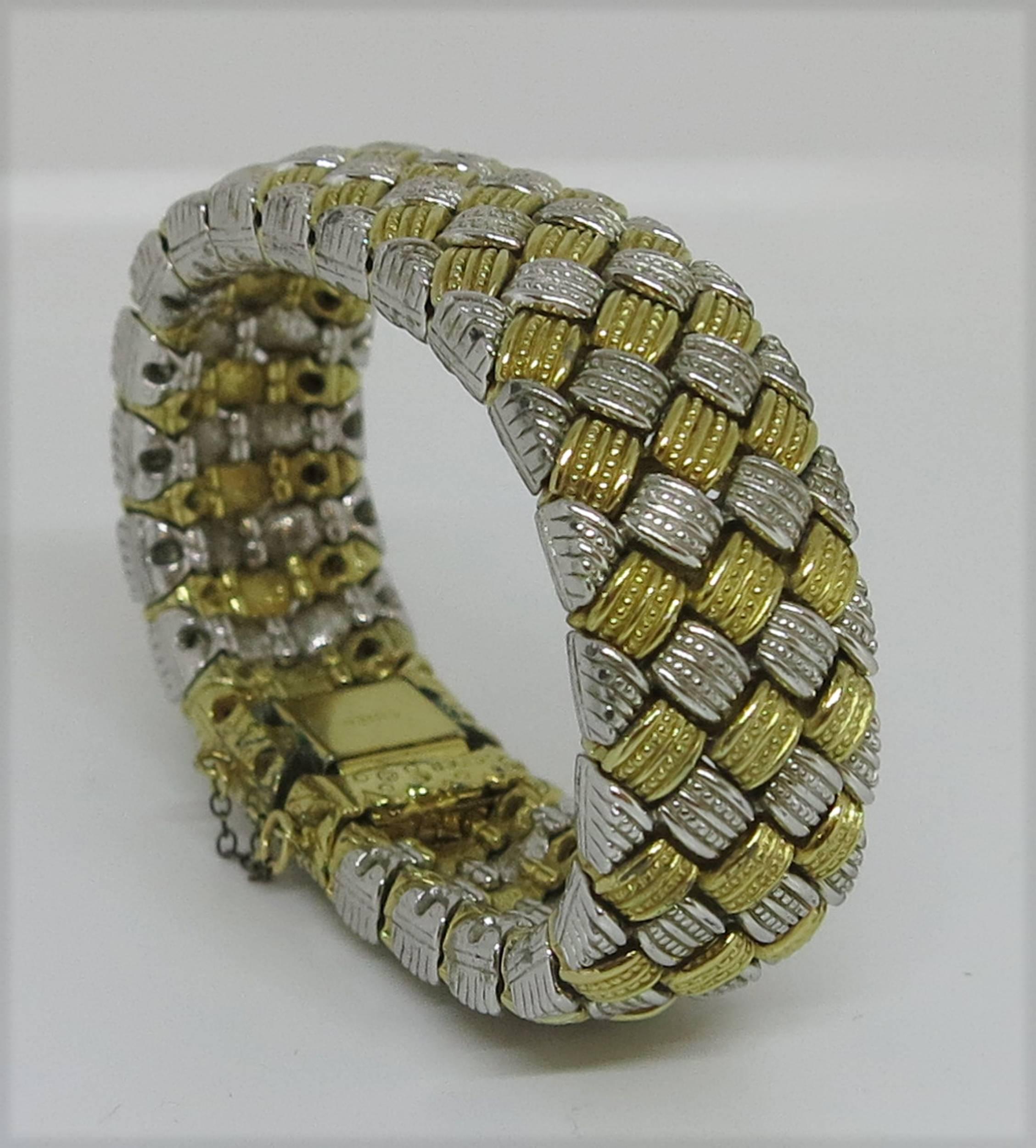 Ciner silver and gold basket weave metal bracelet...Press catch to lock with security chain...Approximately 7 1/2