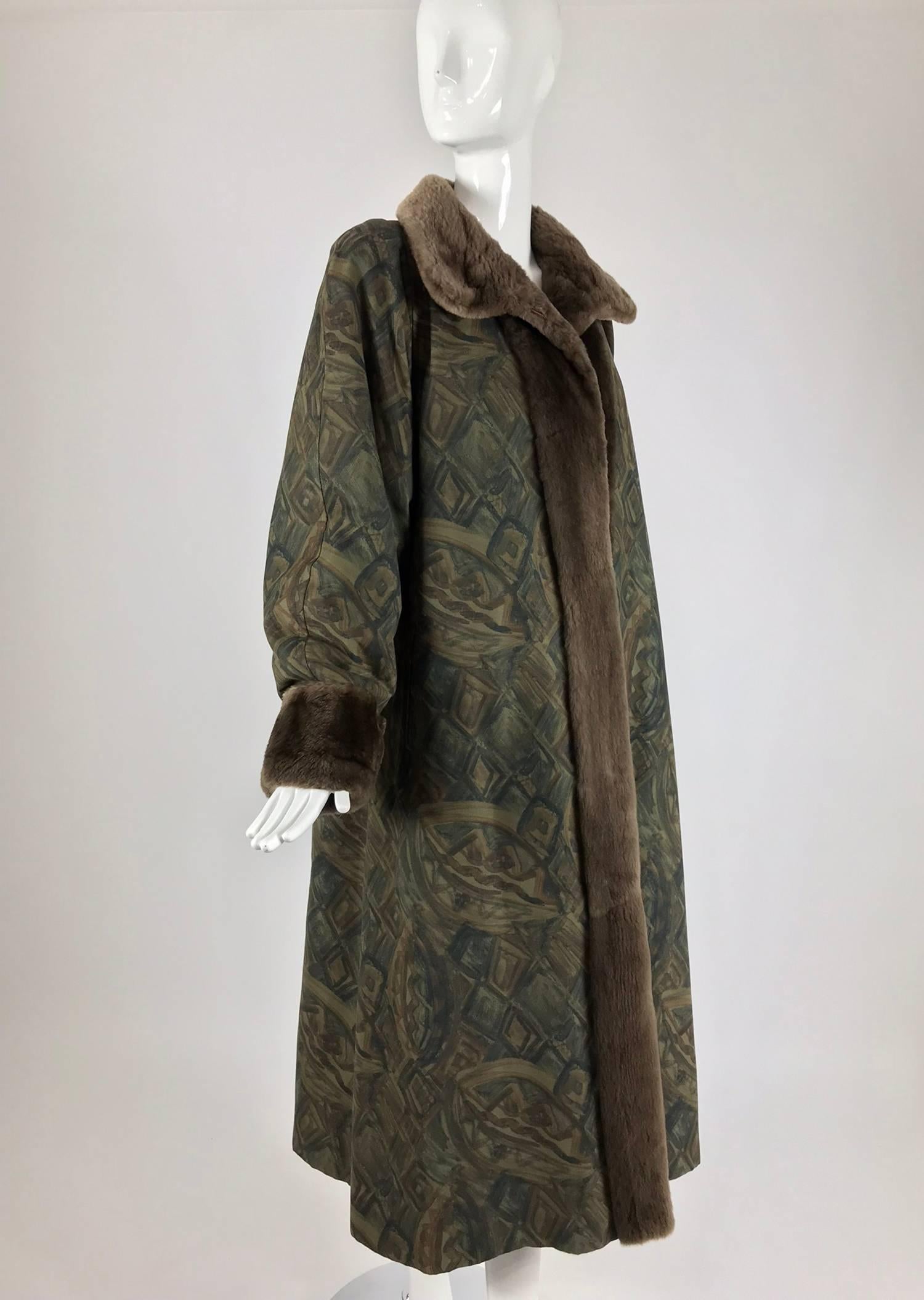 Anne Klein Reversible sheared beaver and fabric coat from the 1990s. The fabric print, in muted tones, gives the illusion of hand painting. Long full coat flares at the hem. Fully lined in soft soft sheared beaver fur. Long full sleeves with turn