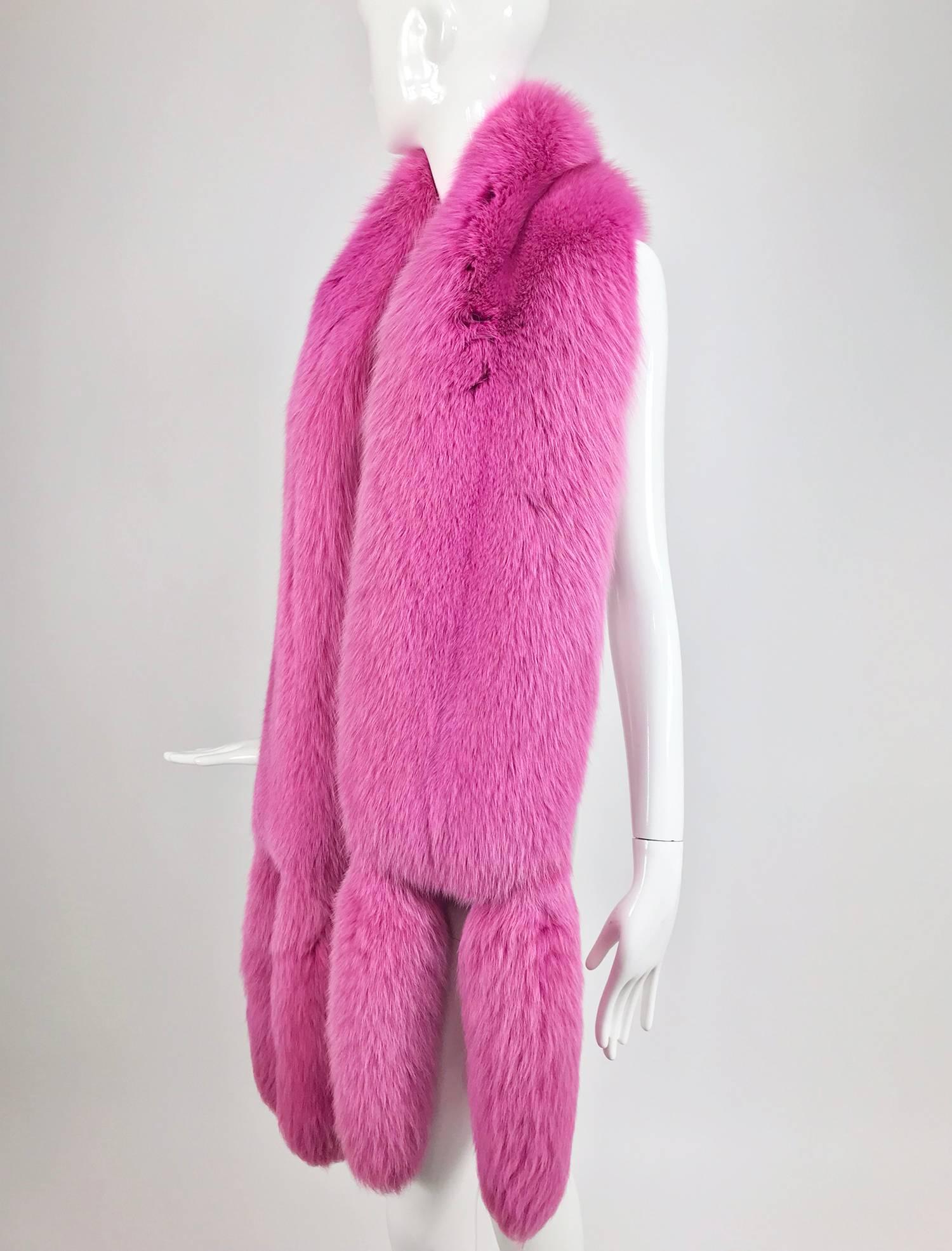 Hot Pink fox fur stole with tails from the 1980s...Beautiful thick fur with double tails at each end...Lined in hot pink moire taffeta...In excellent condition...

In excellent wearable condition... All our clothing is dry cleaned and inspected for