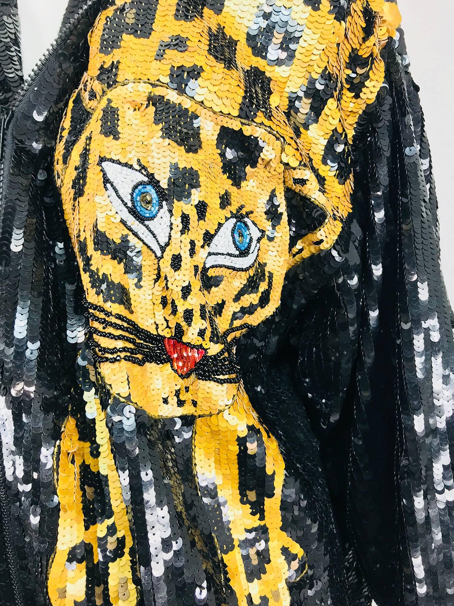 Modi novelty sequined leopard bomber jacket from the 1980s...Completely covered in sequins this jacket features a blue eyed leopard displayed over one shoulder with his rear and tail on the back of the jacket...Oversized with padded shoulders, 3/4