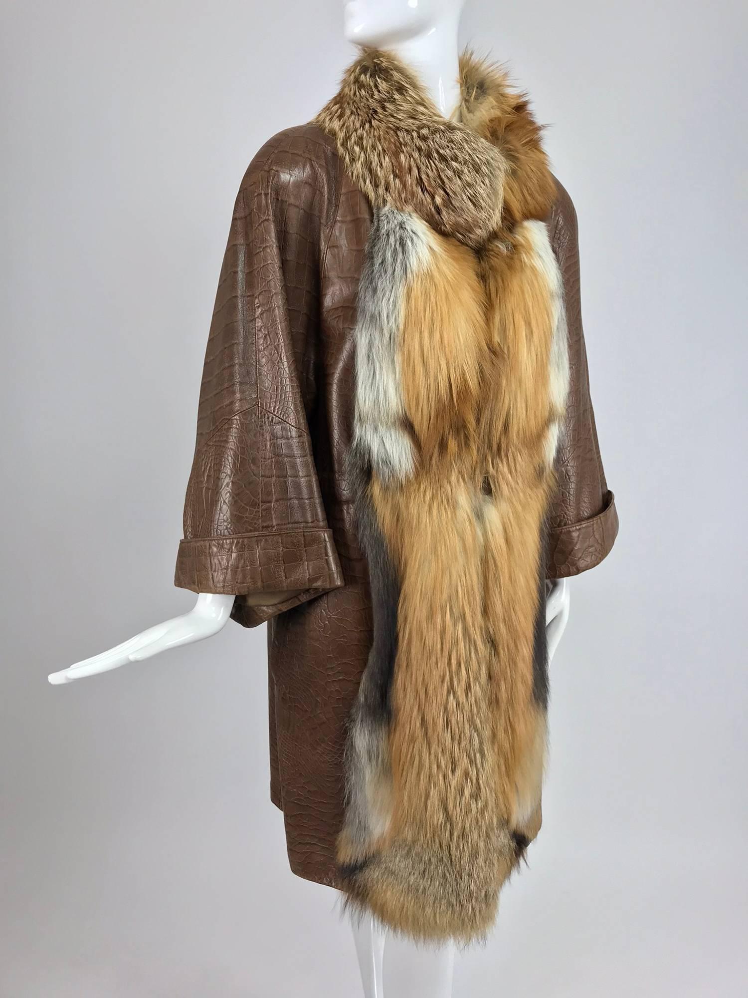 Amen Wardy embossed soft leather alligator (print) coat with red fox fur trim from the 1980s...This coat has raglan sleeves with full turn back cuffs, a draw cord at the waist and hip angled besom pockets...The collar and facings are trimmed with