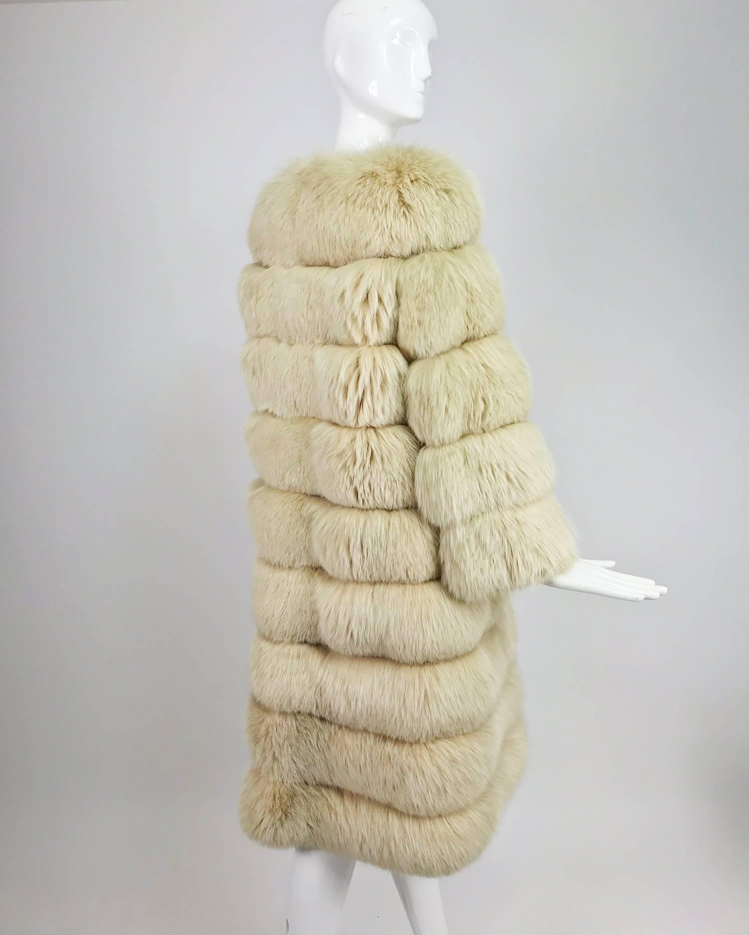 Cream Fox Fur and suede coat with removable hem from the 1970s...Horizontal bands of lush cream fox fur are interspersed with narrow bands of soft buff suede...There are hip front pockets...The bottom two rows of fur zip off to make a shorter