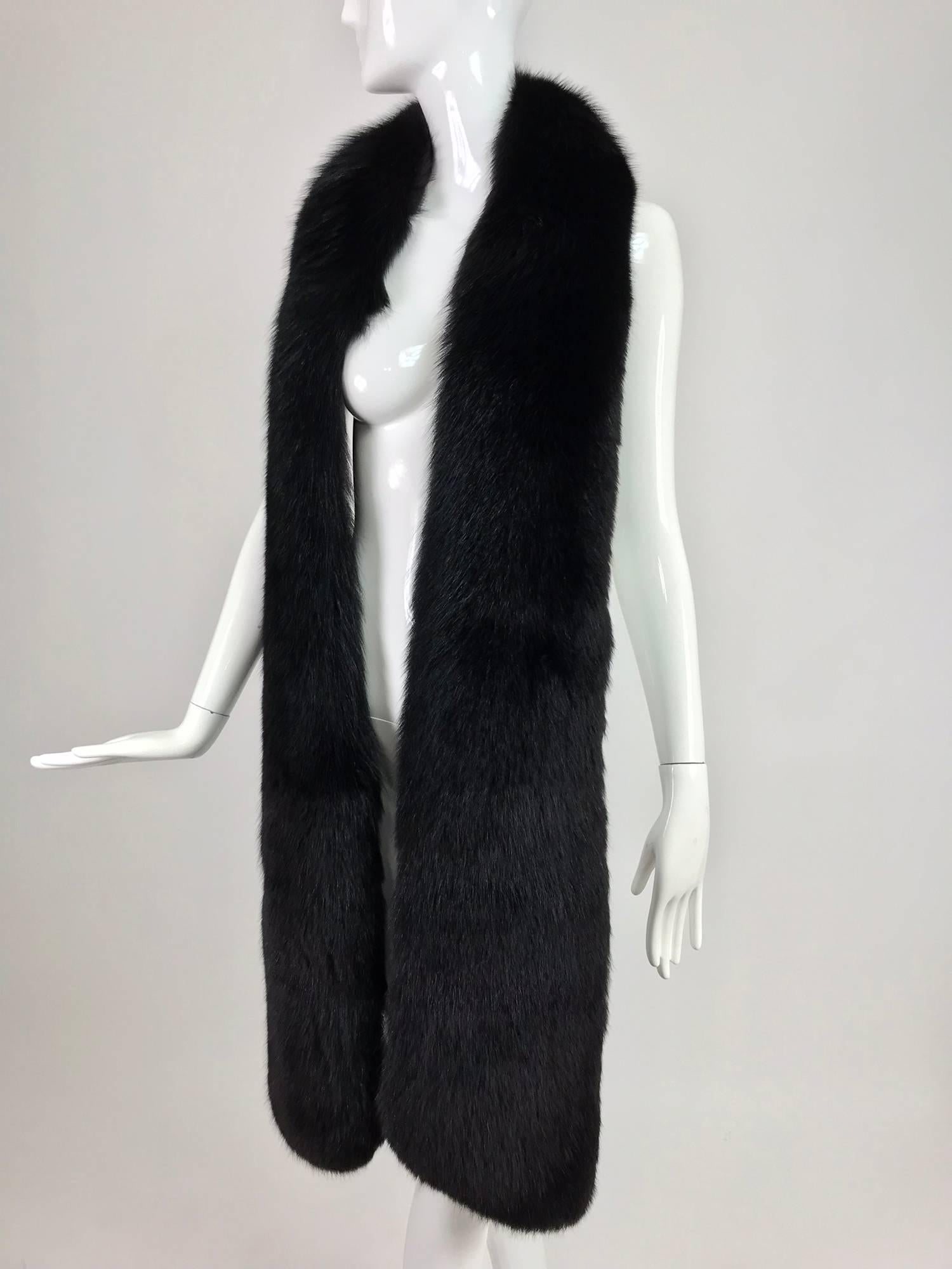 Black fox fur long stole from the 1960s...Full and soft black fox fur long stole perfect for wearing over a coat...Fully lined in velvet...

In excellent wearable condition... All our clothing is dry cleaned and inspected for condition and is ready