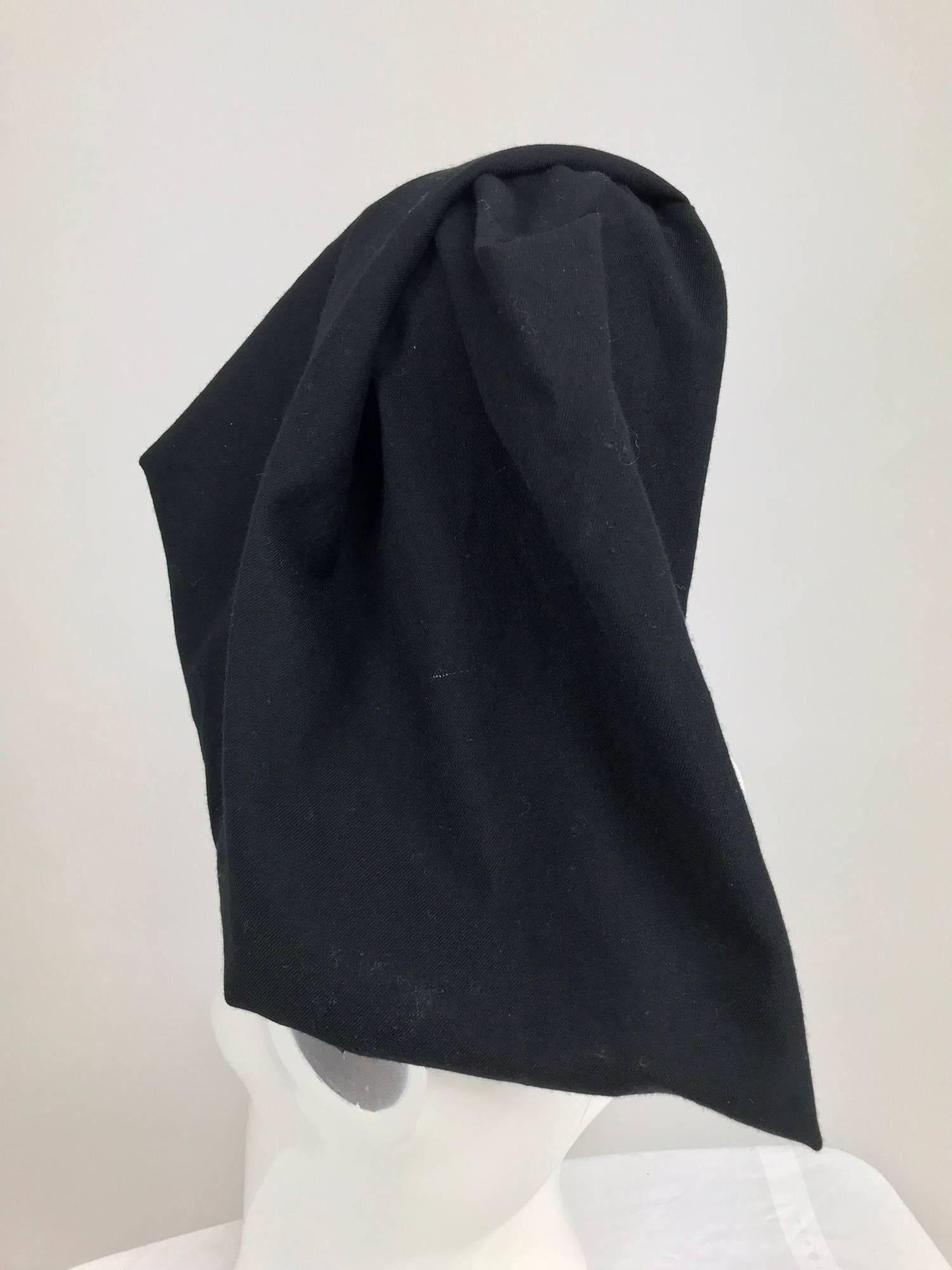 Comme des Garcons black wool asymmetrical hat...Seamed hat can be worn at many angles...Head band with narrow black banding trim...Unlined...
In excellent wearable condition... All our clothing is dry cleaned and inspected for condition and is ready