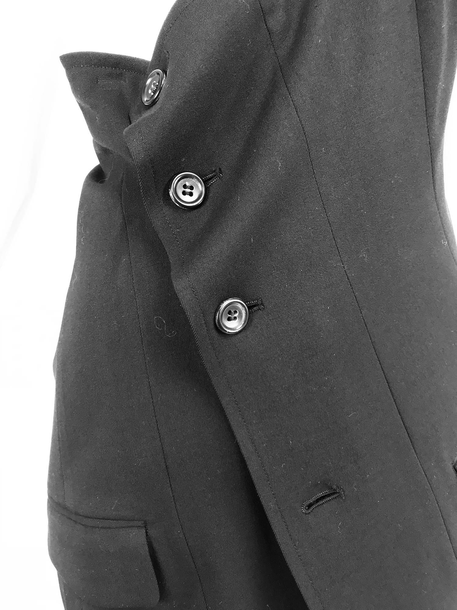 Comme des Garcons asymmetrical black wool one shoulder angled button front tunic...Side back gathered opening/pocket...Fully lined...Angled button closure with flap pockets at either hip front...One cap shoulder...Marked size Medium about a size