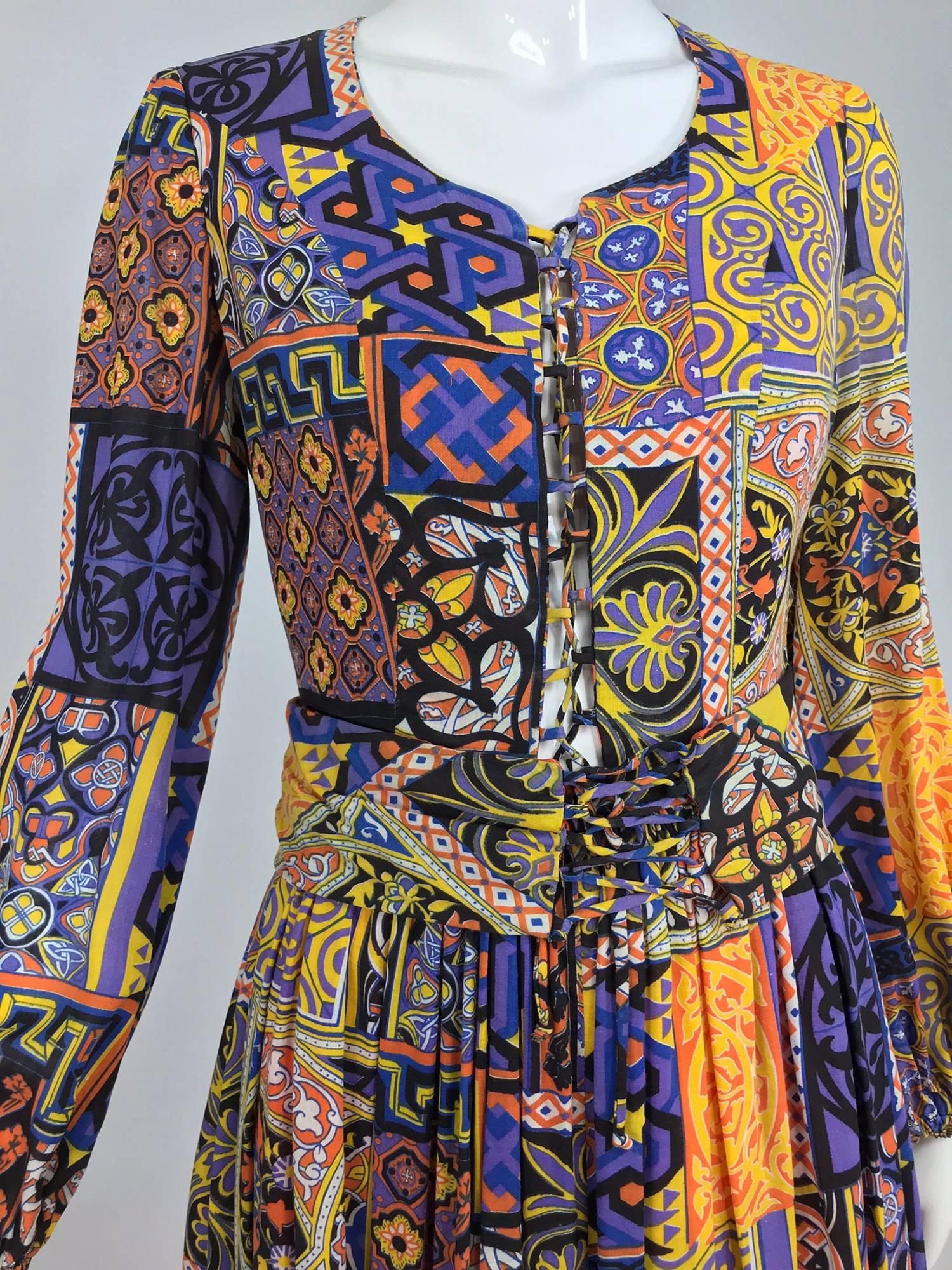 Moorish mosaic cotton print laced front bohemian dress from the 1960s. Beautiful print done in square blocks of geometric and floral designs in purples, yellows, oranges, blacks. The scoop neckline laces at the front, neck to waist, with self cords.