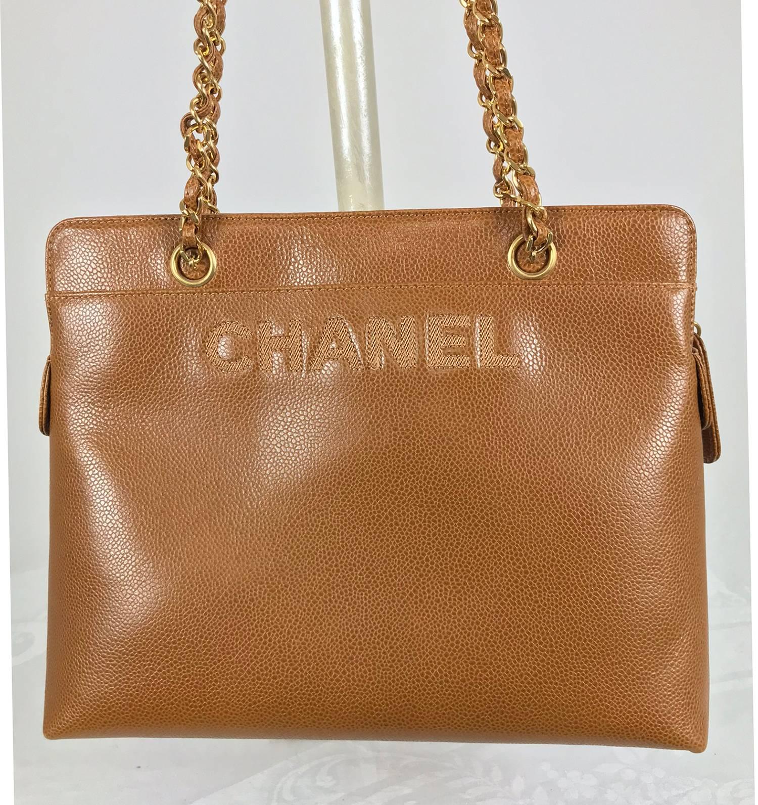 Chanel caramel pebble leather chain strap shoulder bag from the 1990s, never used. This beautiful bag is a rich caramel colour the leather has a light pebble texture. Chanel is embroidered in large letters at the upper front of the bag, there is an