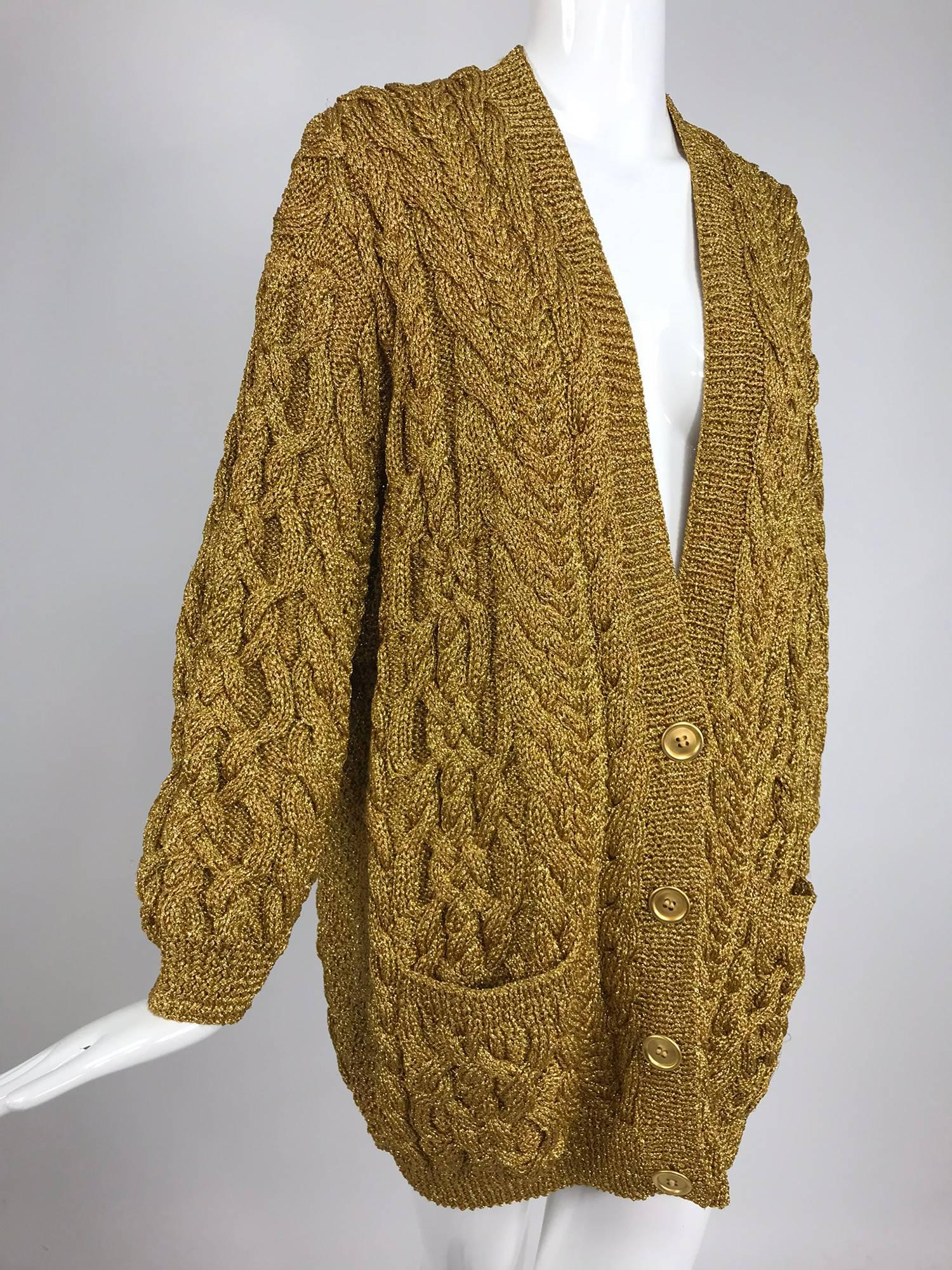 Anne Klein chunky oversize gold metallic knit cardigan sweater from the 1990s. Cable knit sweater has V neckline and 4 gold buttons to close. Hip front pockets. Unlined, looks unworn. 
In excellent wearable condition... All our clothing is dry