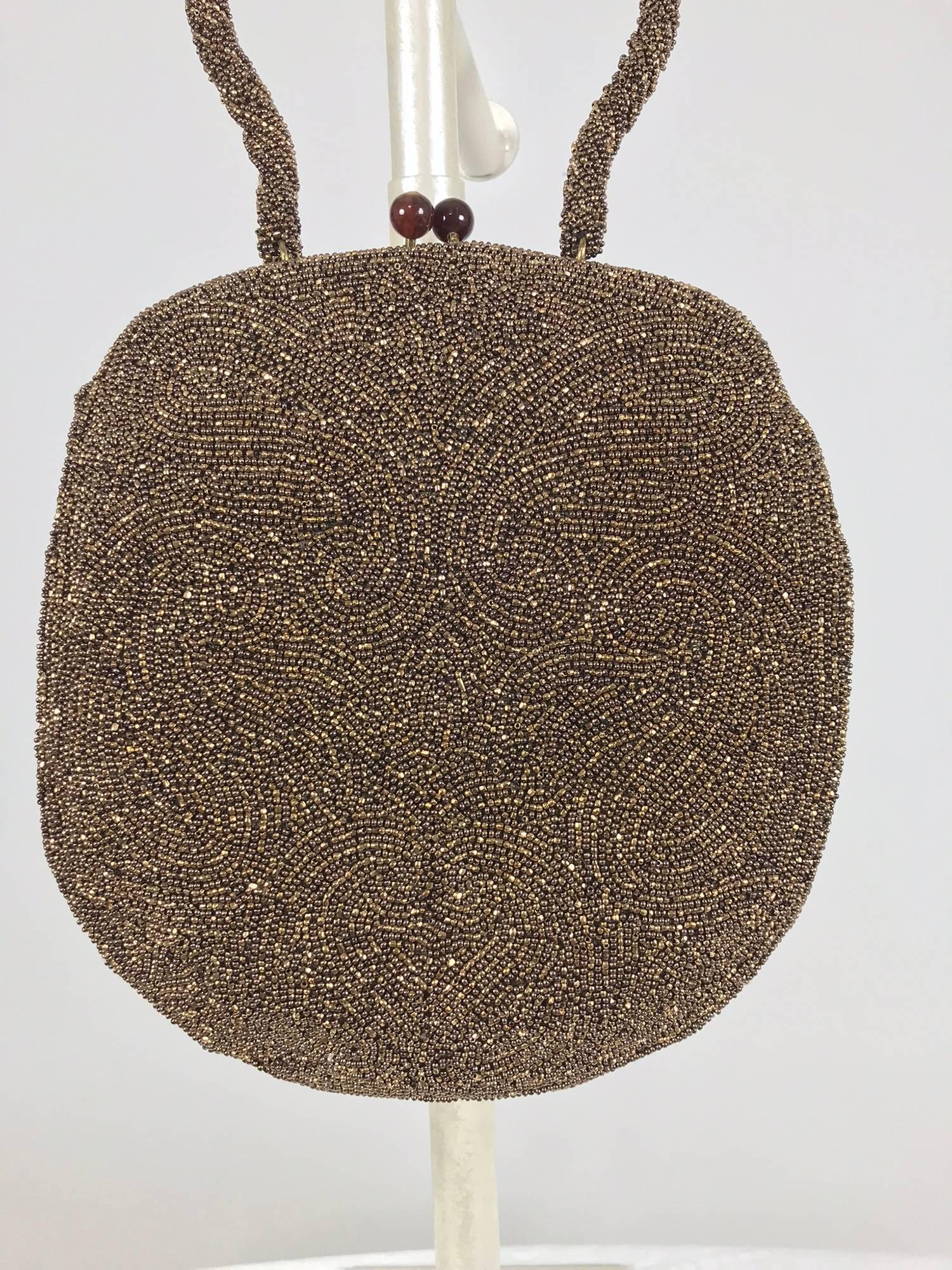 Walborg unique copper beaded frame evening bag from the 1940s, new with the original tag. This beautiful bag has a oval-ish shape which is unique. The handle is bead covered and shaped. The bag closes with tortoise shell coloured Lucite ball kiss