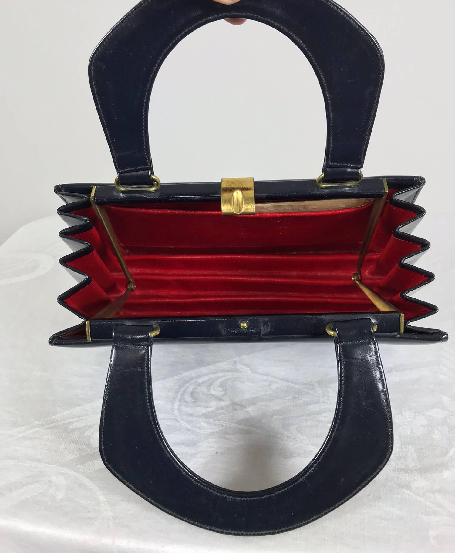 Susan Gail Original navy blue box calf Accordion handbag from the 1950s. Structured bag with in internal frame and shaped double handles. Brass hardware with a clasp opening at the top, there are some scratches on the clasp. The interior is lined in
