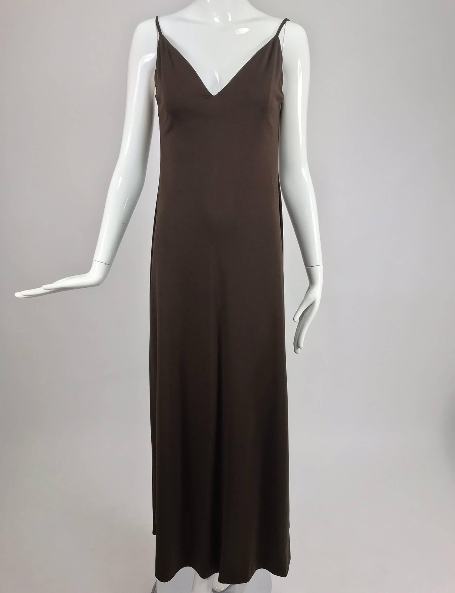 Estevez chocolate brown jersey maxi dress and jacket from the 1970s. Body hugging A line maxi dress with matching cropped, long sleeve jacket with a single button front closure. The slip style dress has a V neckline and low back, narrow shoulder