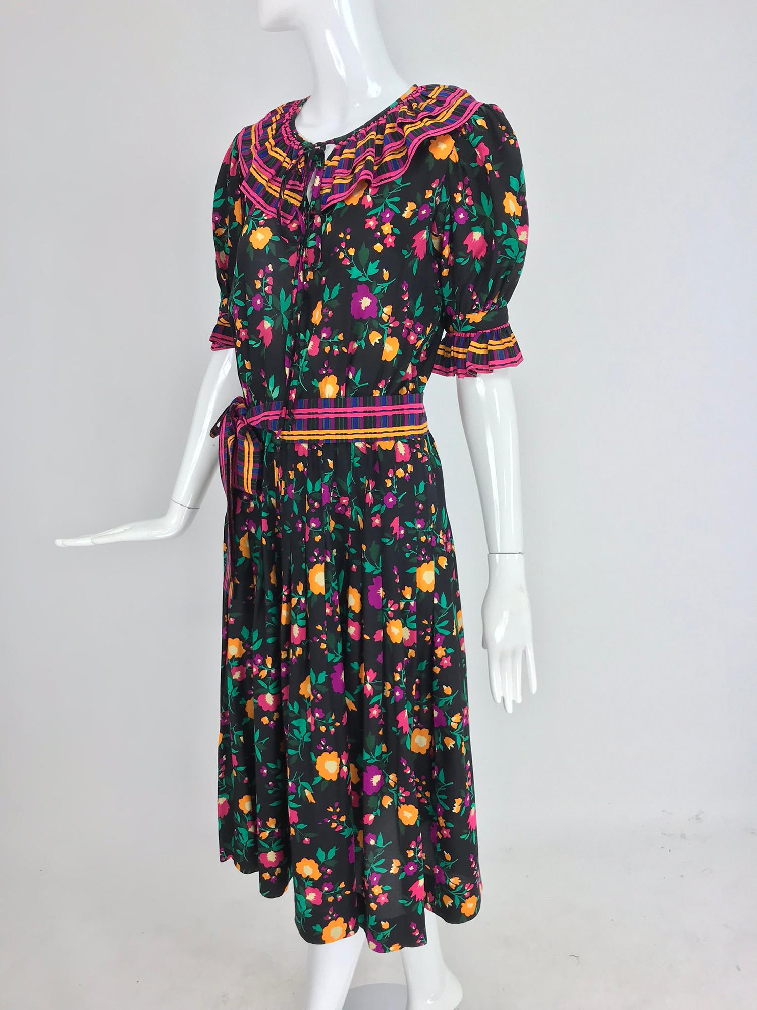 Yves Saint Laurent Rive Gauche silk floral mix print dress from the 1970s. Vibrant floral print set on a black ground with coordinating stripes make this eye catching dress perfect for anytime you want to look fabulous. Pull on dress has a peasant