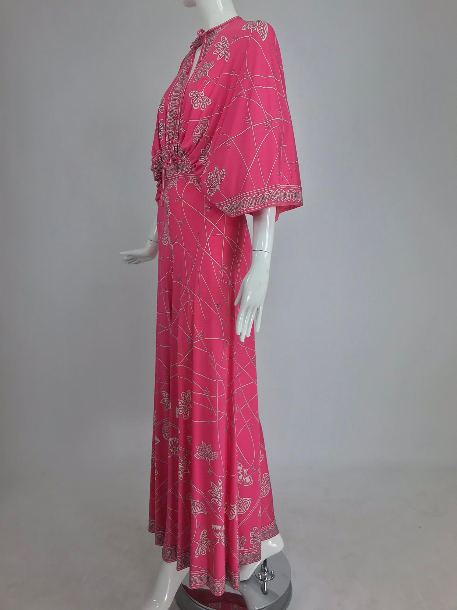 Emilio Pucci flamingo pink silk jersey plunge top and palazzo trouser from the 1970s. This amazing and rare Pucci set has a bat wing, full sleeve top that is open at the center front and back from the neck to the waist, the waist has cased elastic