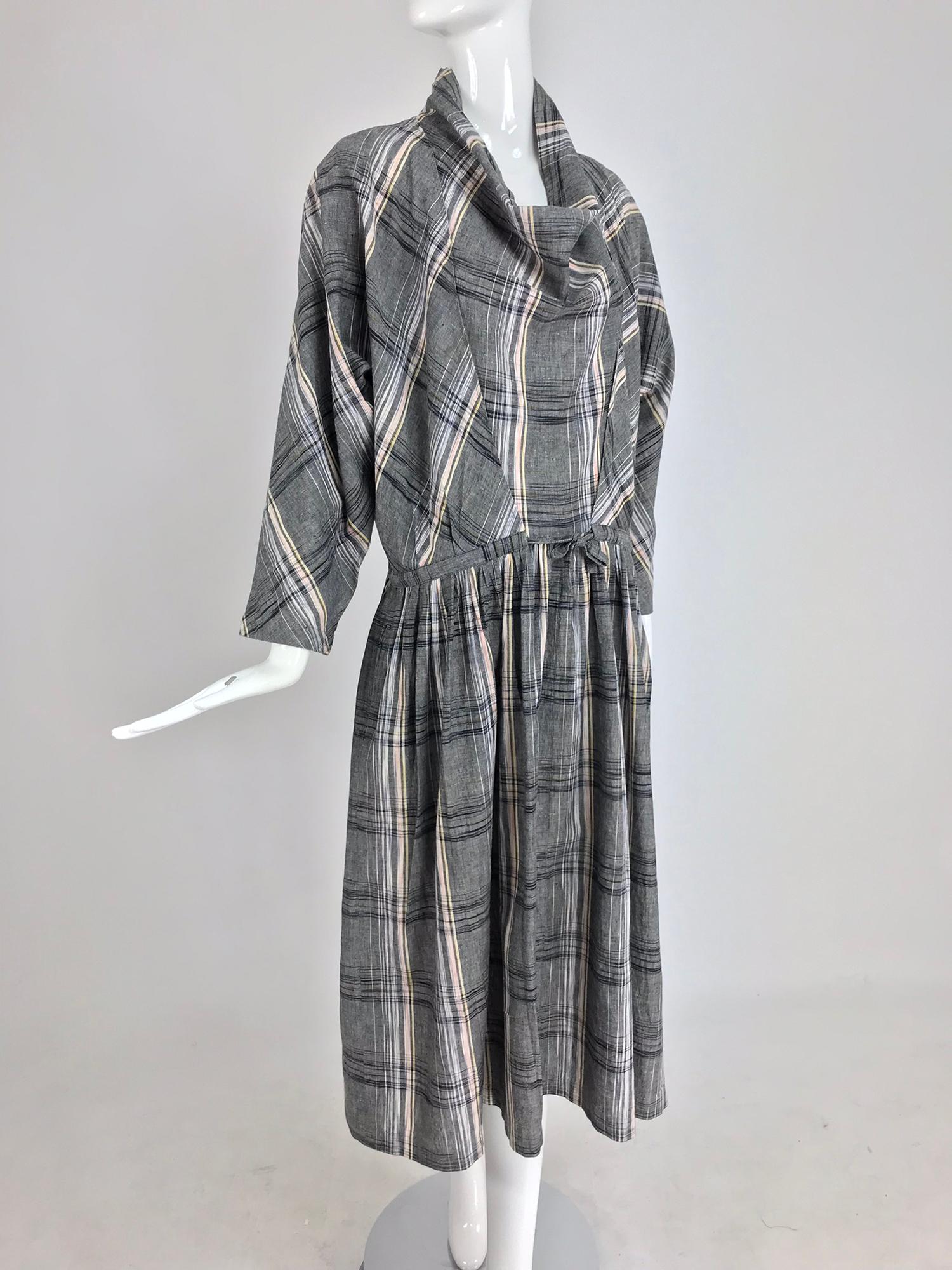 Issey Miyake Funnel Neck Plaid cotton Draw Cord waist dress from the 1980s. Chambray cotton plaid oversize dress has a funnel neck, with 3/4 length full sleeves, low draw cord waist and full skirt. The dress pulls on and is unlined. Marked size