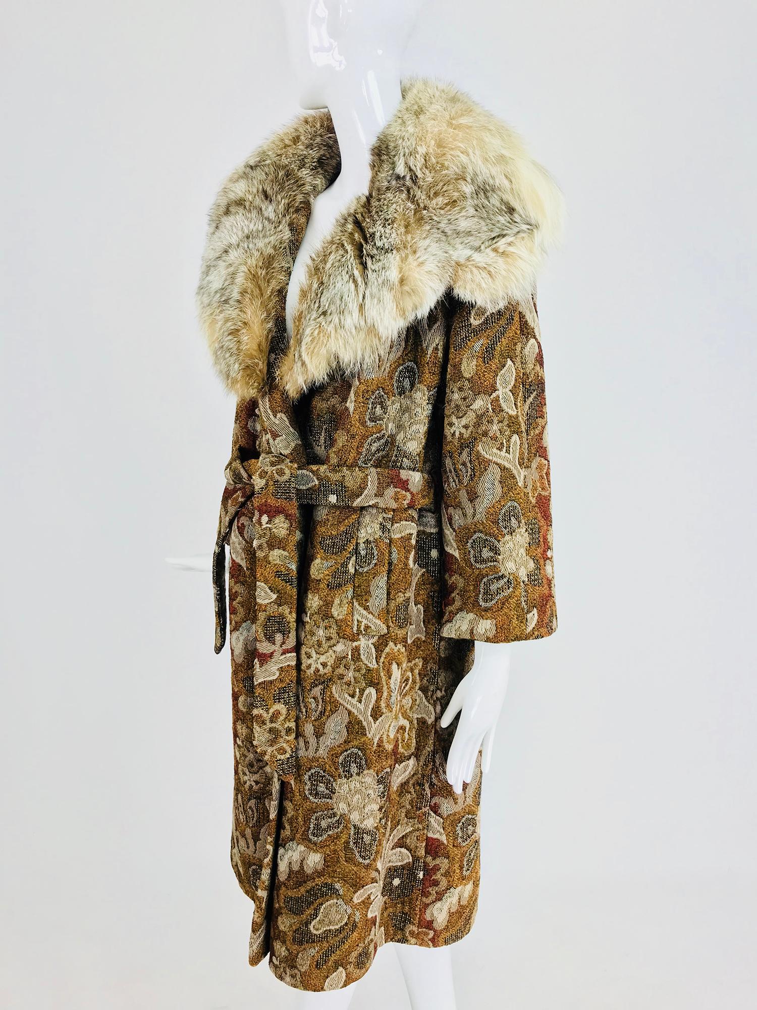 Tapestry coat with fur collar and wrap belt 1960s from Abraham & Straus NY. This tapestry coat woven in autumn shades with a floral design and a deep lush fur collar is sure to keep you warm on the coldest days. The coat has a tent shape and closes
