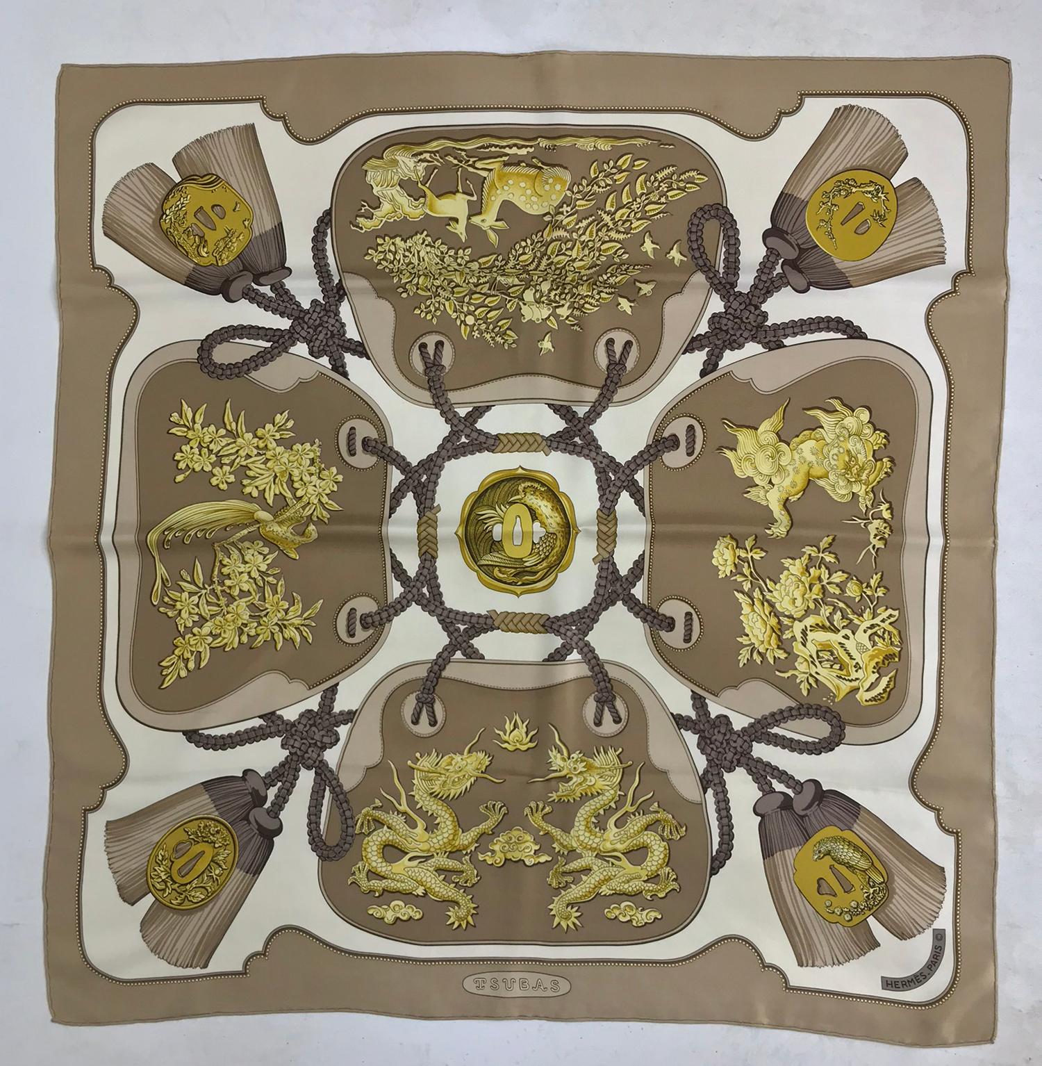 Hermes Tsubas Silk Twill Scarf  Designed by Christiane Vauzelles 35 x 35. Beautiful scarf in tan, gold and cream.
A couple of light marks that are hard to find, this scarf has been professionally dry cleaned.