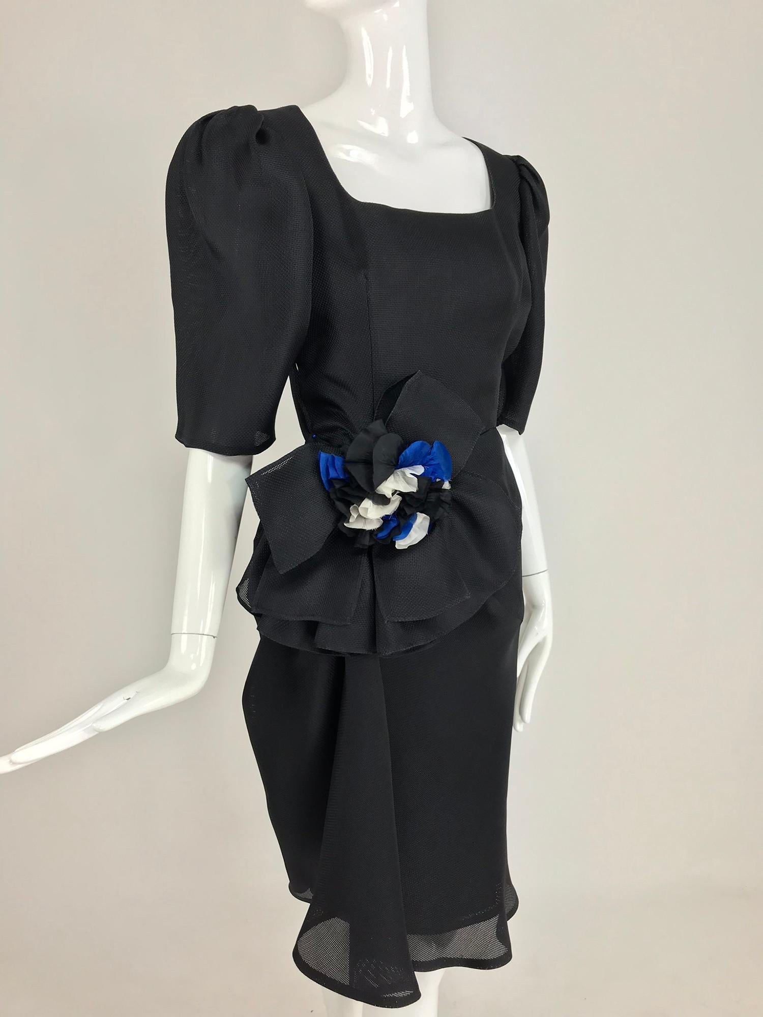 Givency Black Textured Silk Dress with Hip Bow from the 1990s. Givenchy captured the essence of Paris in this dress, the elegant chic that French women are known for.  Created of an open weave silk the neckline is wide and open with peaked 3/4 elbow