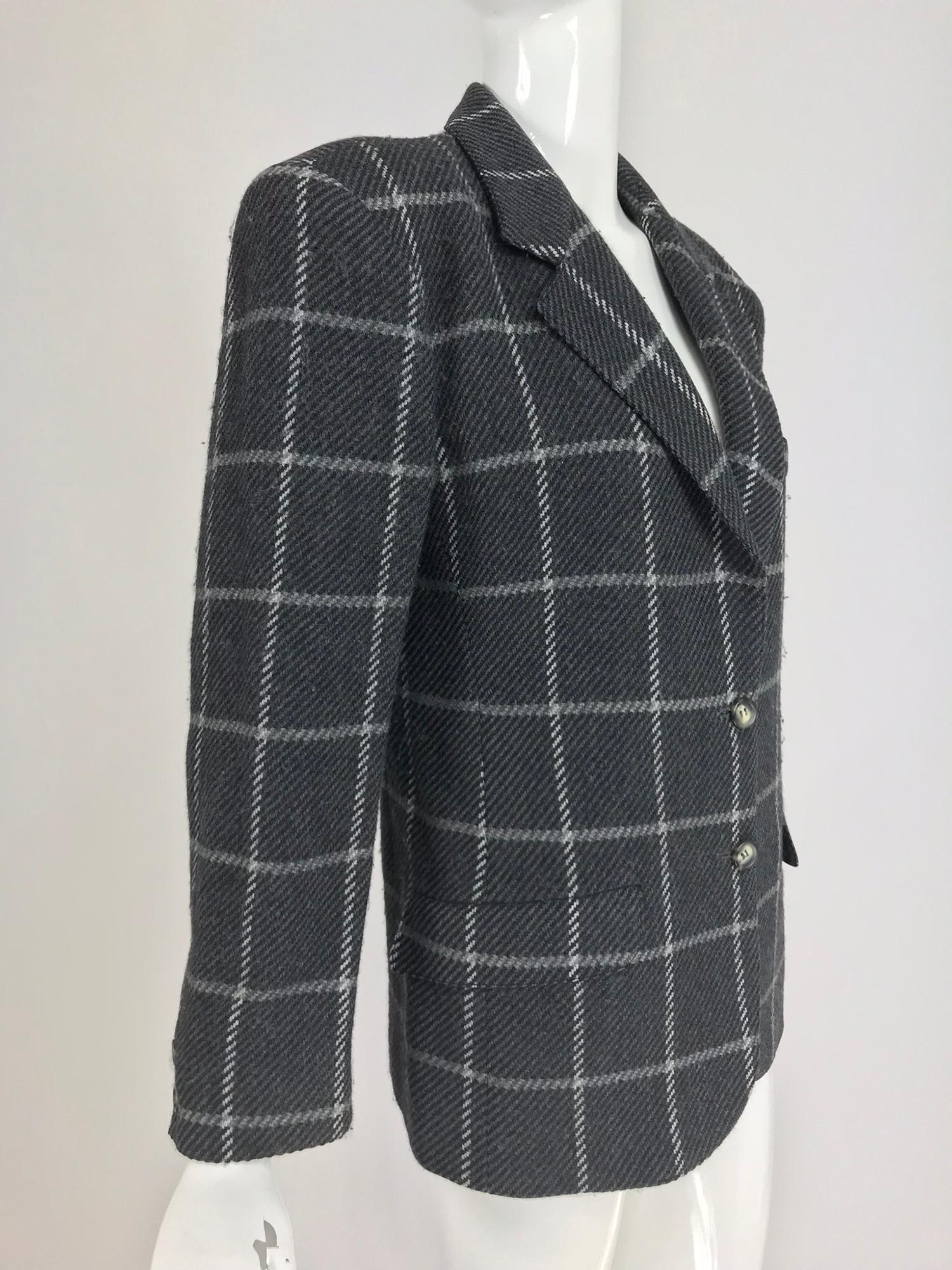 Gucci Charcoal Windowpane Check Wool and cashmere Blazer from the 1980s. Single breasted jacket has notched lapels, padded shoulders, a single besom breast pocket and double hip flap front pockets. Fully lined in black rayon.  Marked size 40.

In