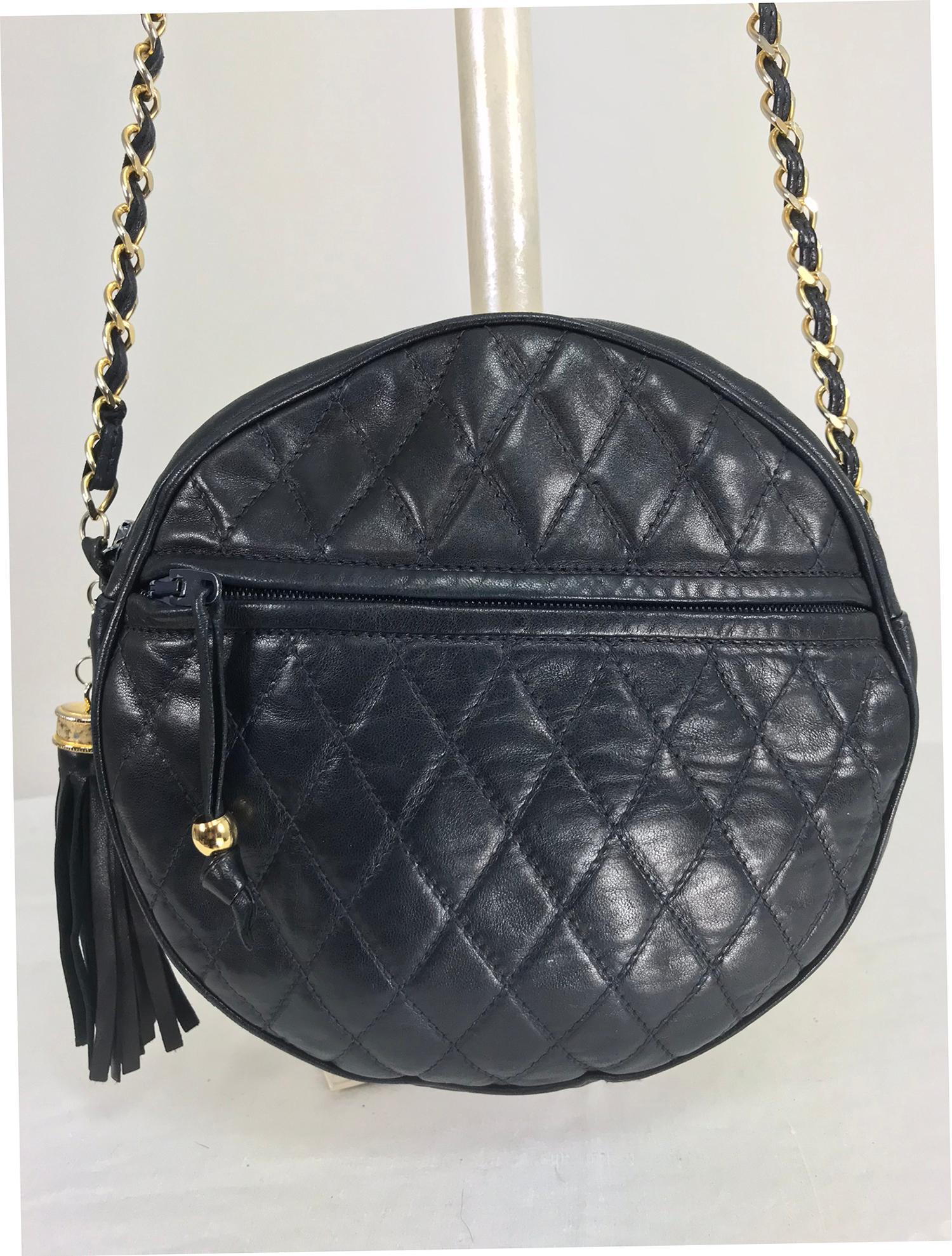 SISO Italy round navy lambskin quilted leather shoulder bag from the 1980s.  Buttery soft lambskin in dark navy blue, quilted bag with front zipper compartment, large side tassel, gold hardware, and long leather threaded gold chain strap. Interior