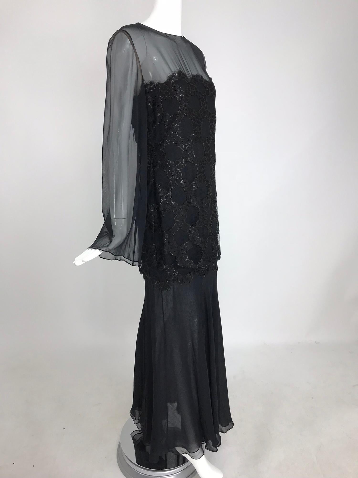 Bill Blass lacquered lace black silk chiffon evening dress from the 1970s. This beautiful evening gown has never been worn and still has the original tags. Jewel neckline dress has long sheer bell sleeves, the bodice, through the bust to the hip has