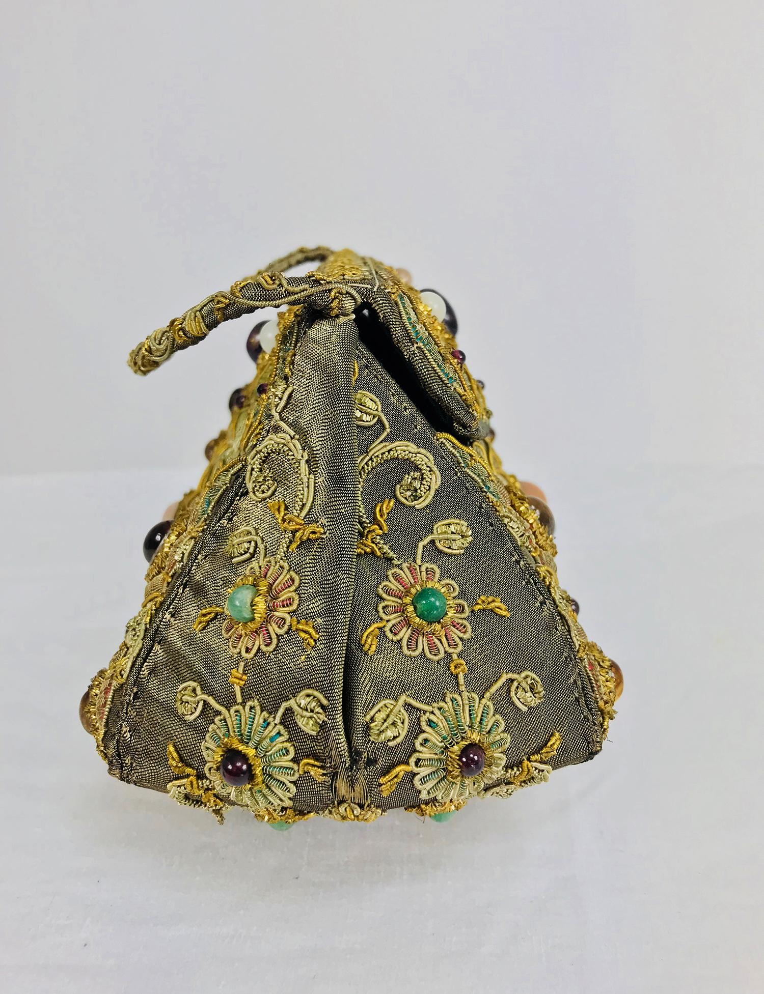 Metallic jewel lame Mughal evening bag India from the 1960s. This beautiful bag has a unique shape and a lovely patina, made from burnished silver lame, it is covered with couched gold metallic thread, and applique work floral motifs sewn with semi