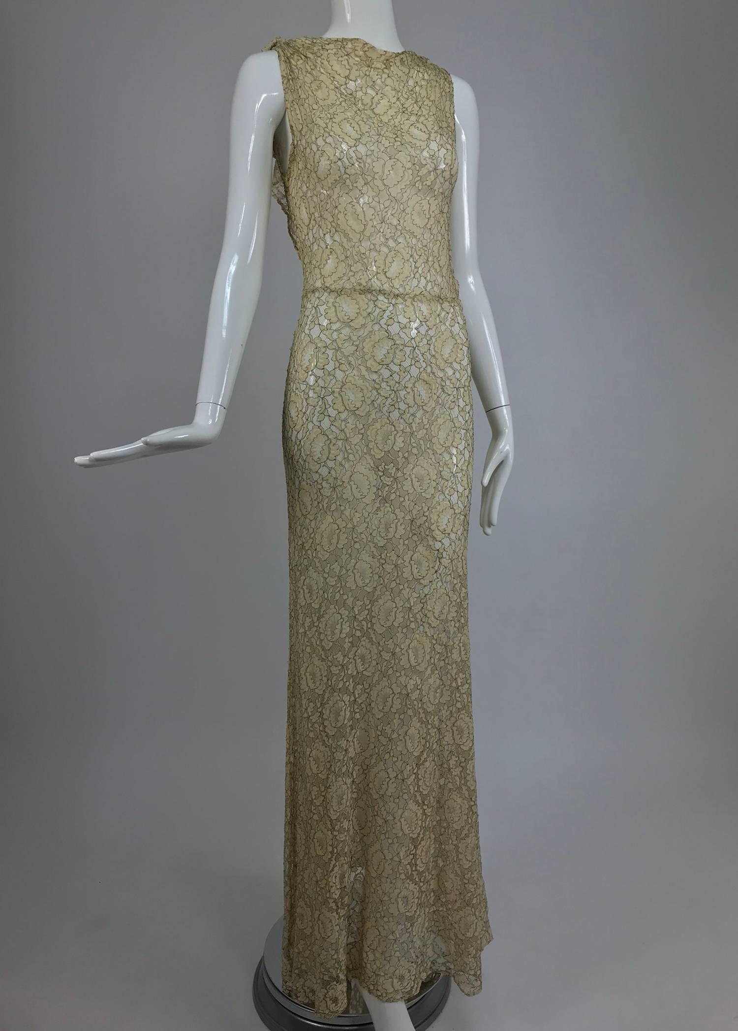 1930s Mixed gold metallic thread cream lace evening dress. This beautiful dress would make an amazing wedding gown. The fabric is cream lace that is re embroidered with gold metallic thread, giving the dress a very golden look. The neckline is cut