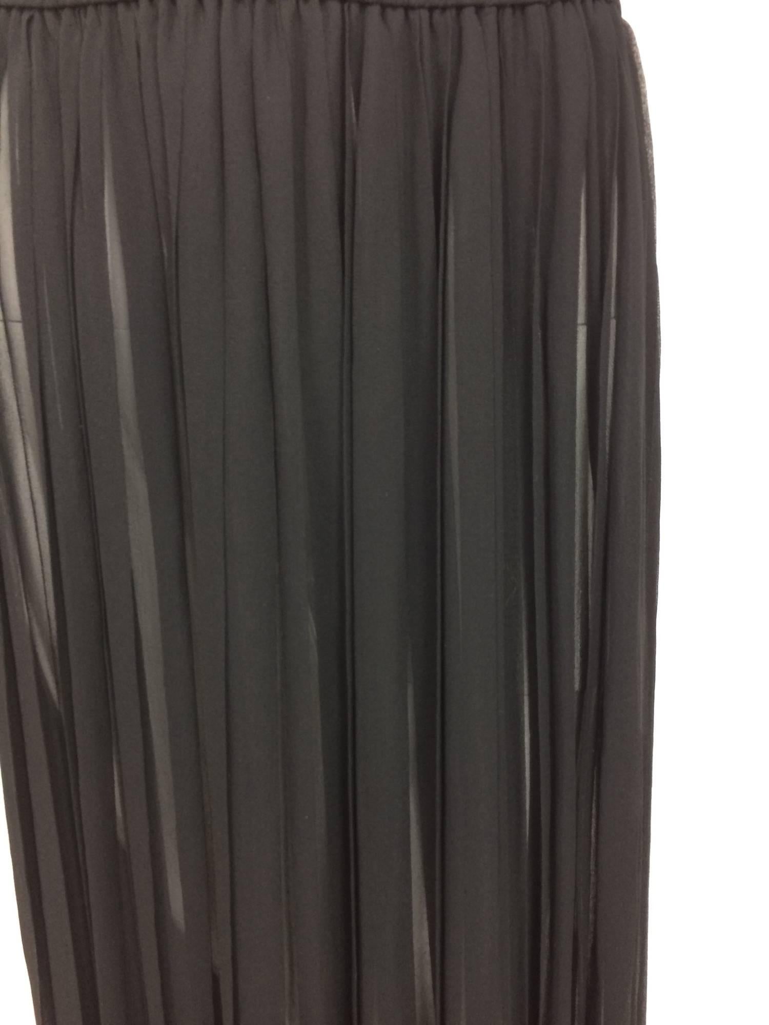 Yves St Laurent knife pleated black silk sheer chiffon maxi skirt from the 1970s. Cased elastic waist. Sexy sheer silk chiffon maxi skirt . Marked size 38

In excellent wearable condition... All our clothing is dry cleaned and inspected for