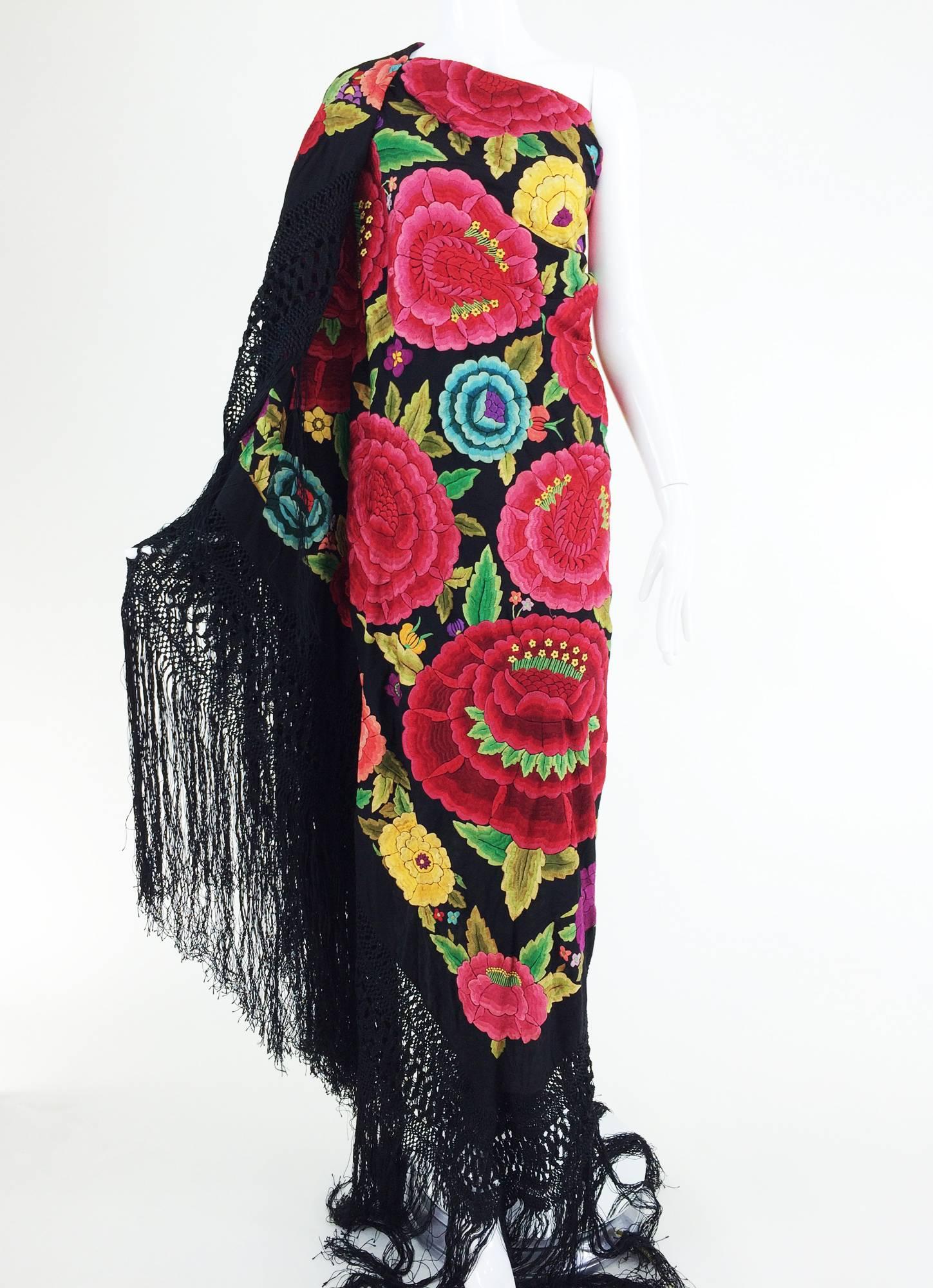  Hand embroidered Spanish manton shawl from the 1920s...Heavily embroidered black silk with very large roses in vibrant pinks with smaller flowers in various colours...Shawls of this size with such dense embroidery are rare to find anymore, this