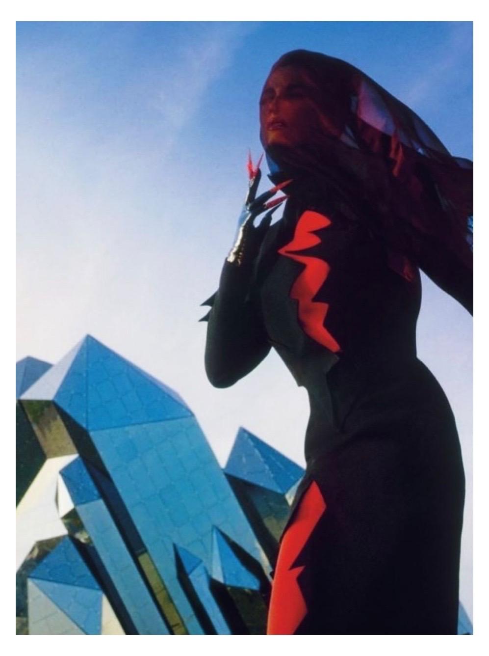 Add edge and drama your wardrobe with this Thierry Mugler black lightning bolt dress from the Fall Winter “Les Infernales” 1988 collection and seen on the runway. This dress features a mock neck collar, long sleeves, shoulder pads, and a zigzag
