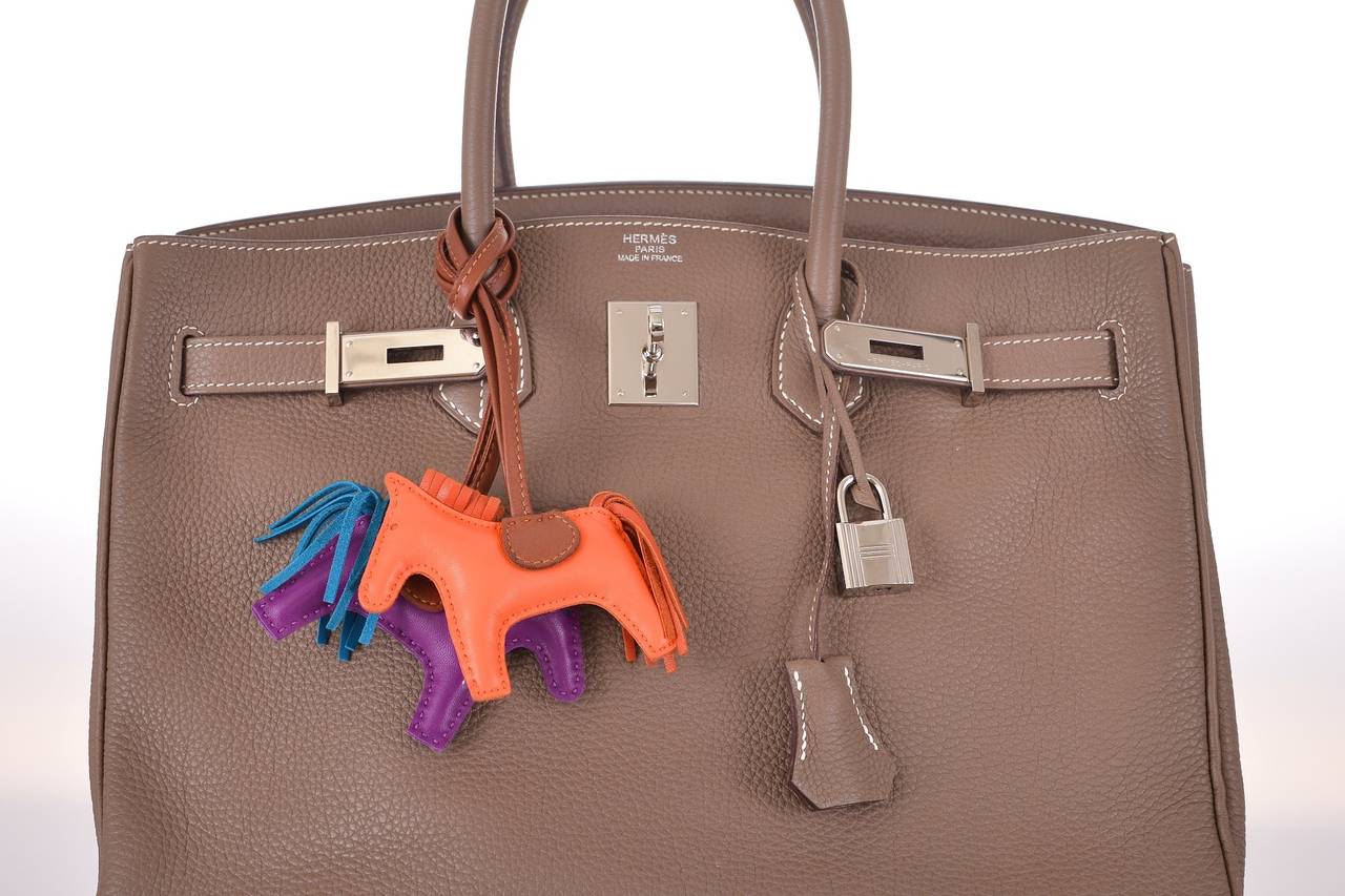 As always, another one of my fab finds! The Hermes 35cm BIRKIN in  beautiful CLEMENCE leather in the most beautiful Etoupe color with contrast white stitching.

This bag comes with lock, keys, clochette, and a sleeper for the bag.
The bag is
