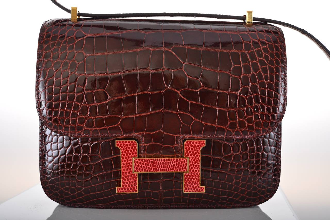 As always, another one of my fab finds! STUNNING  Hermes Constance in ALLIGATOR. PERFECT size 18cm! Very rare FIND in the SHINY new BORDEAUX  COLOR BOURGOGNE ,WITH A PINK LIZARD BUCKLE & GOLD HARDWARE. Comfy double strap that is perfect to carry