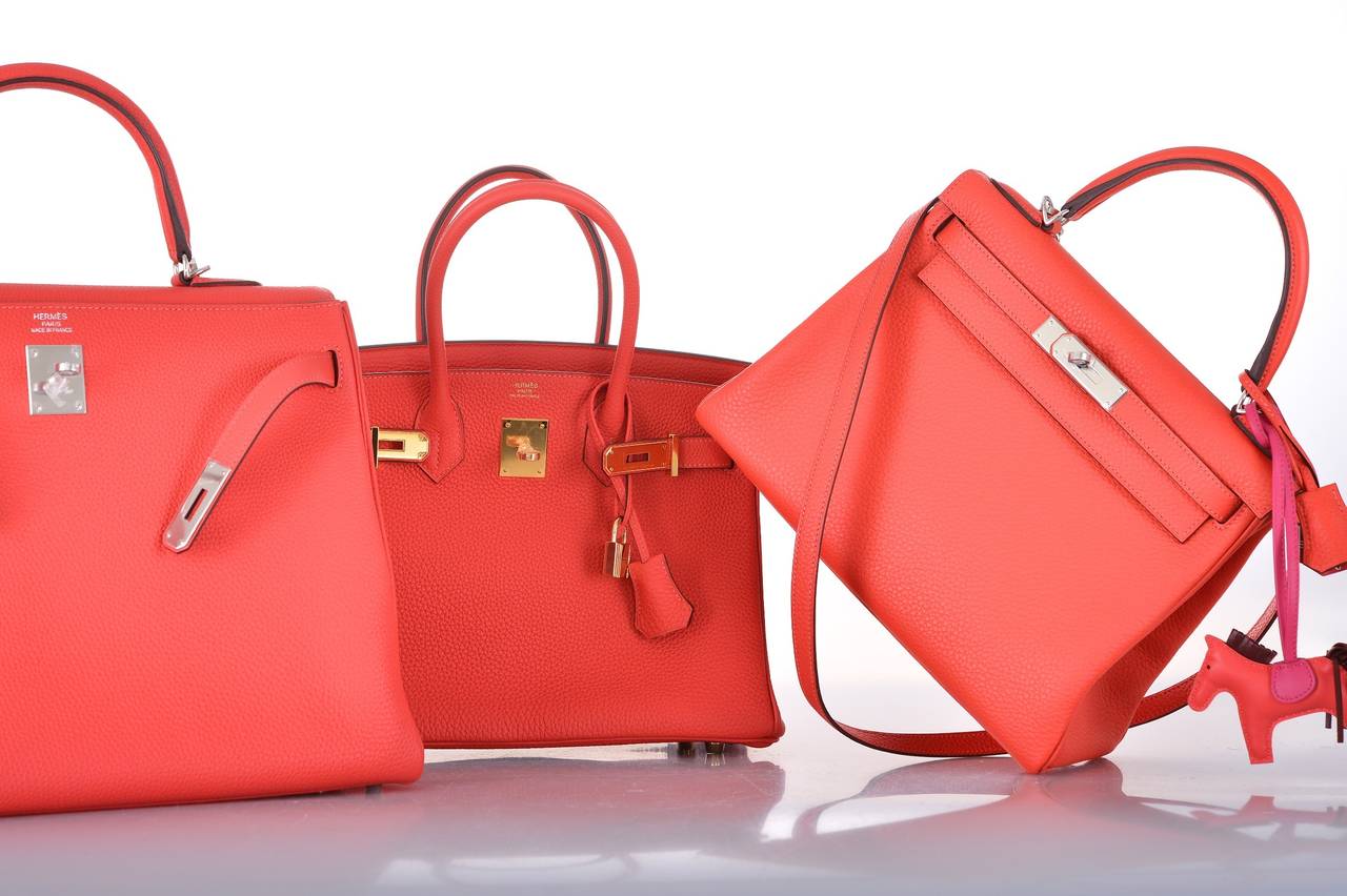 As always, another one of my fab finds! Hermes 28cm Kelly in beautiful BRIGHT ROUGE PIVOINE with palladium hardware.

This bag comes with lock, keys, clochette, a sleeper for the bag, rain protector, box, ribbon.
The bag is Brand NEW WITH PLASTIC
