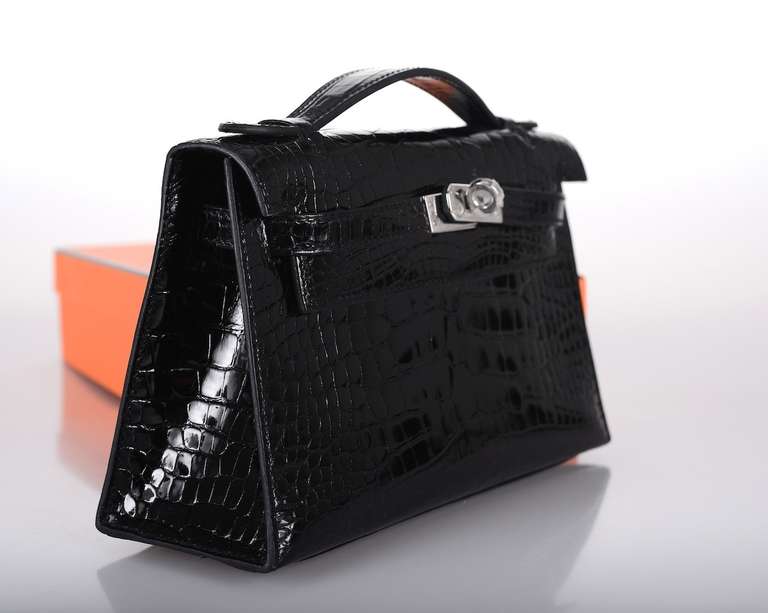 As always, another one of my fab finds! Hermes Kelly Jpg pouchette in STUNNING SHINY BLACK nilo CROCODILE. Perfect companion for anytime you don't want to carry your Kelly or a Birkin. Fits all the necessities. I love the handle!

                