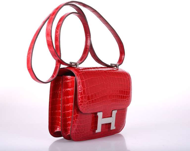 As always, another one of my fab finds! Hermes Constance in a PERFECT SUPER RARE size 18cm! Incredible RED BRAISE nilo crocodile with palladium hardware. Actually big enough for everyday use. Comfy double strap that is perfect to carry cross body or
