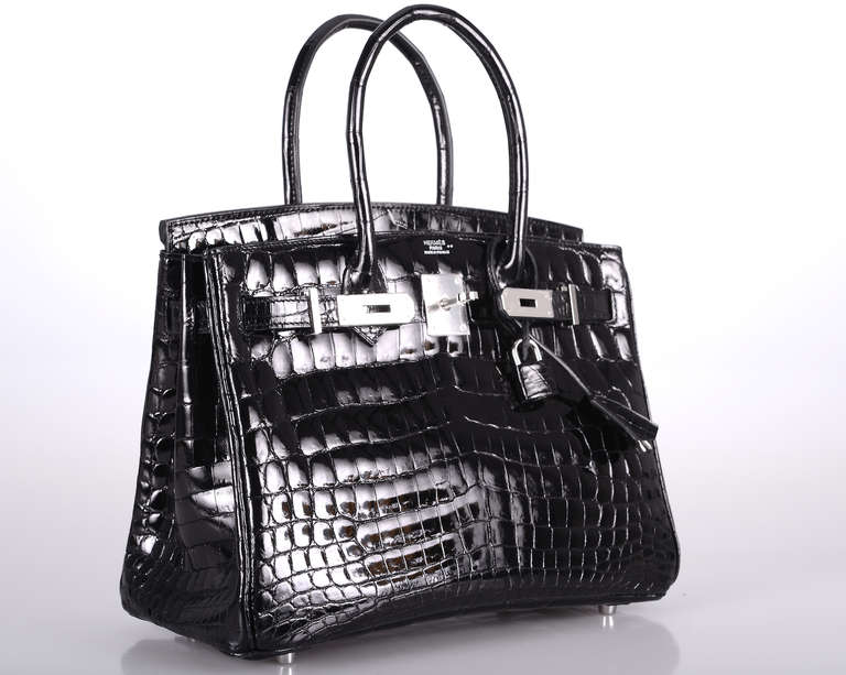 HERMES BIRKIN BAG BLACK NILO CROCODILE WITH PALLADIUM HARDWARE.
IN ABSOLUTE PRISTINE CONDITION! COMES WITH A BOX AND ALL THE ACCESSORIES. 
THE BAG IS STAMPED J. IMMACULATE! AND A RARE NILOTICUS CROCODILE with GORGEOUS SCALES.