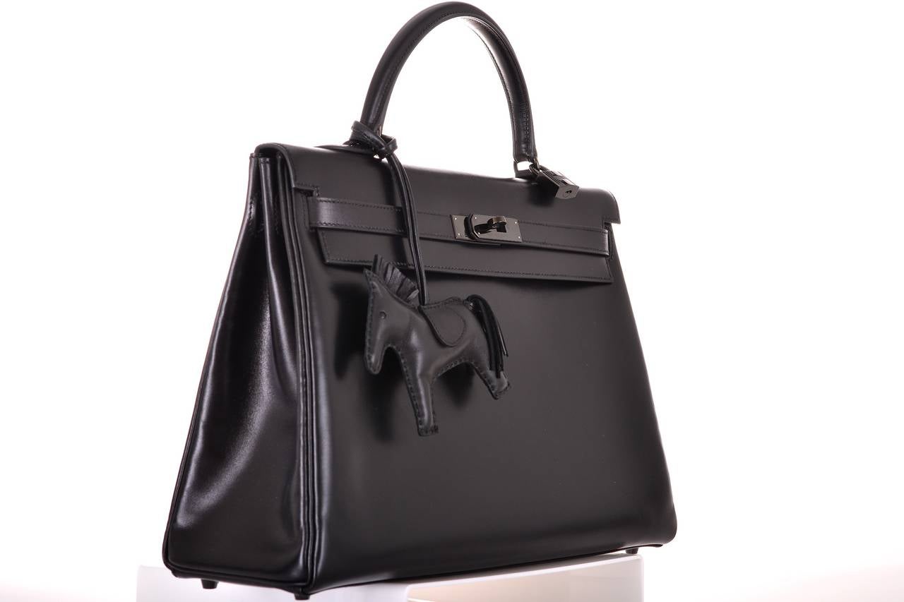 As always, another one of my fab finds! NO longer in production LIMITED Hermes 35cm SO BLACK box leather KELLY.
THIS BAG WILL TAKE YOUR BREATH AWAY! TRULY A MASTER PIECE!
PLEASE NOTE:  SO BLACK KELLY WAS DESIGNED WITHOUT A SHOULDER STRAP. 
This