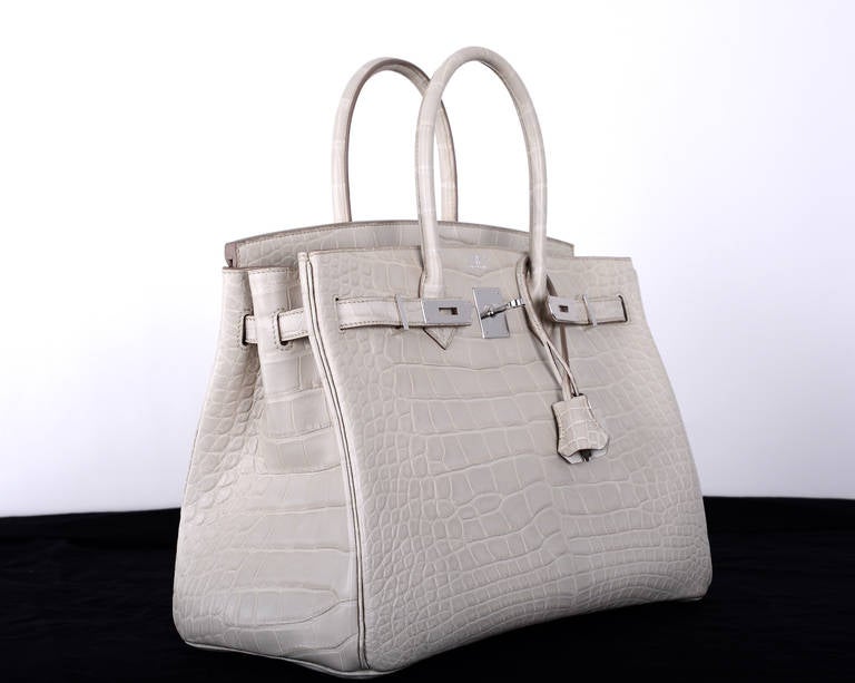 As always, another one of my fab finds! The sexiest bag ever… Hermes 35cm Birkin in beautiful BETON MATTE ALLIGATOR WITH BEAUTIFUL palladium HARDWARE. THIS BAG WILL TAKE YOUR BREATH AWAY!

This bag comes with lock, keys, clochette, a sleeper for