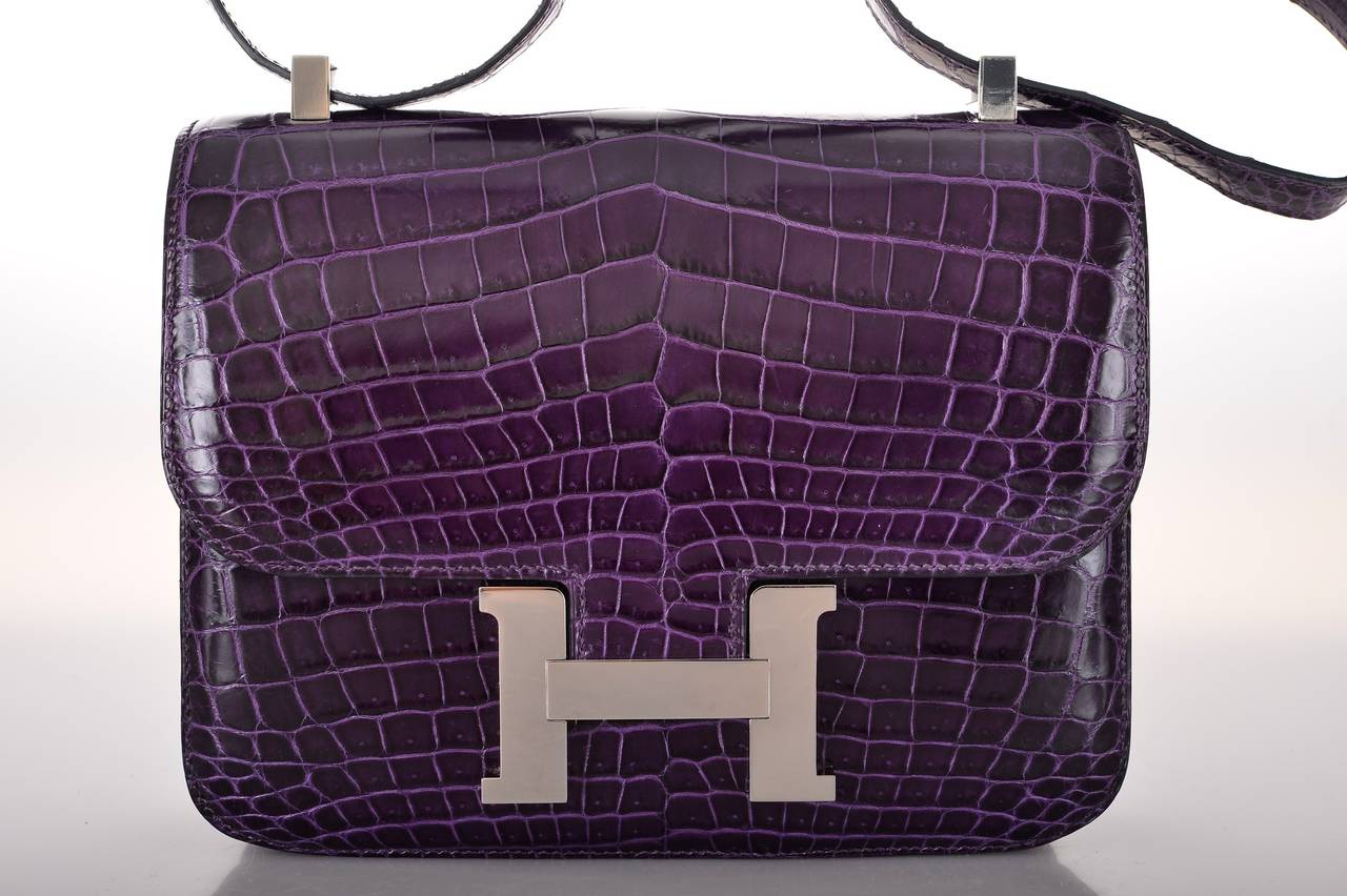 As always, another one of my fab finds! Hermes Constance in a PERFECT SUPER RARE size 24cm! Incredible AMETHYST nilo crocodile with palladium hardware. Actually big enough for everyday use. Comfy double strap that is perfect to carry cross body or